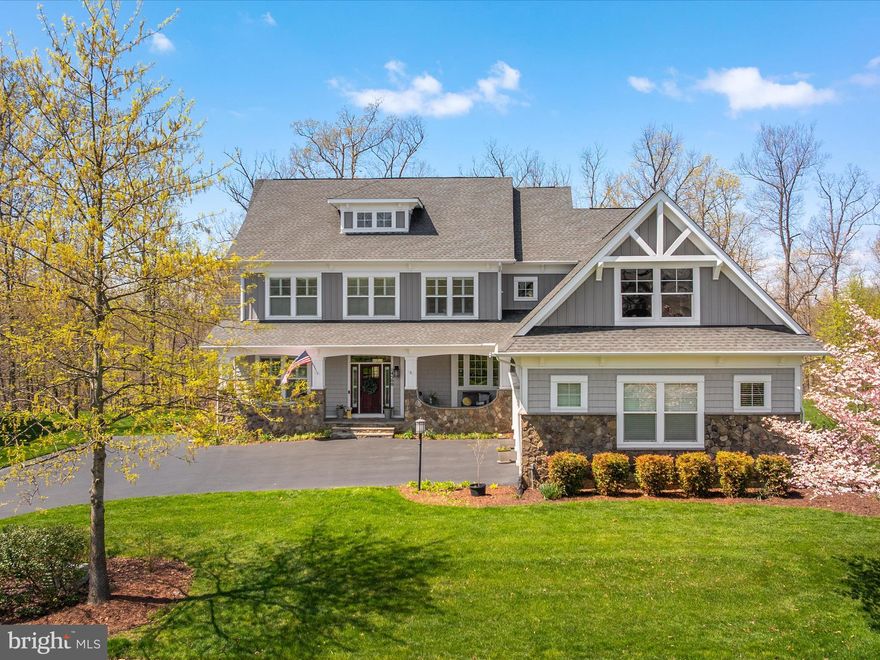 This inviting home sits at the end of a quiet cul-de-sac, offering a peaceful retreat with stunning views of Lake Manassas. A spacious front porch welcomes you in and is the perfect spot to relax and take in the beautiful surroundings. Inside, hardwood floors run throughout the main and upper levels, and craftsman-style trim adds a touch of character and warmth. The large foyer opens to a spacious formal living room and a grand dining room, with windows framing the lake view. A main-level bedroom with a full bath offers flexible space for guests or a home office. The kitchen is both functional and stylish, featuring white upgraded cabinetry, a custom tile backsplash, stainless steel appliances, and a walk-in pantry. It opens to a cozy family room with built-in shelving and a gas fireplace. Just off the kitchen eating area and family room is a covered back porch that feels like an extension of the living space—perfect for outdoor dining or simply enjoying the peaceful view of the backyard, trees, and lake.
Upstairs, the spacious primary suite offers a private retreat, complete with a sitting area, two walk-in closets, and large windows that bring in natural light and lake views. The en suite bathroom includes two separate vanities, a soaking tub, a large walk-in shower, and a private water closet. Two secondary bedrooms share a Jack-and-Jill bathroom, and a fourth bedroom has its own private bath. The laundry room is conveniently located on the upper level. The finished walkout basement adds even more space with a large rec room and fireplace, a media room, a sixth bedroom with attached bath, and finished storage. This home sits on a half-acre lot that backs to woods and open space, with wide-open lake views and sunsets that make it feel like a year-round getaway. Comfortable, spacious, and full of charm—this is lakeside living at its best. 
This unique neighborhood offers resort-style living with over 100 acres of open space, walking trails, a lakeside pool, fire pits, and a log-hewn pavilion. Residents can also fish from the shores of Lake Manassas. This exceptional home is tucked away yet conveniently located just minutes from shopping, restaurants, entertainment venues, transportation, and top-rated schools. Don't miss the chance to own this unique property in the coveted Saranac community.