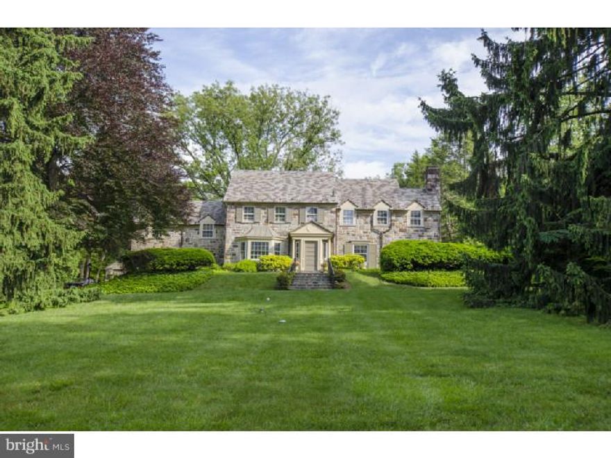 Drive thru the allee of sycamore trees amid the best known estates on the Main Line and turn into the circle drive at 941. Sitting within bucolic perennial gardens, this classic stone manor with slate roof is a rare jewel. Flanked by Italian porcelain urns, the front door opens to a center hall with wide stairs, powder room and French doors with garden views.  An expansive, gracious living room with deep window sills ends in an architecturaly detailed mantel fireplace (gas fired). A formal dining room with exquisite bay window overlooking garden is perfect for entertaining. There is a bright French country kitchen with skylight featuring a two-oven Aga cast iron stove, Jennaire cook top, Sub Zero refrigerator, granite counters with eating-bar and space open to the breakfast room.  The family room and library are cozy places to read or gaze thru the wall of windows to the patio and the artistically landscaped private gardens. The master suite is elegant, spacious & receives the morning sun thru a large picture window. It is served by abundant closets and built-ins, an en suite bath with double sinks. Four additional bedrooms and two full baths complete this floor. In the finished lower level, enjoy the barn paneled bar/pool area and the fabulous media cove with high-end surround sound, big screen TV and parlor seating.  From the French doors, step out to a lovely brick patio with an original PA blue stone grill bedecked with flowers.  Walk up the steps over a slate stone path leading thru lush plantings to the substantial sized pool and its pergola with hot tub and pool cabana. This meticulously maintained and updated estate offers elegance and privacy, a truly unique property and a must see.   It is all here, an entertaining mecca with ample guest parking and amenities to share?.waiting for you!
