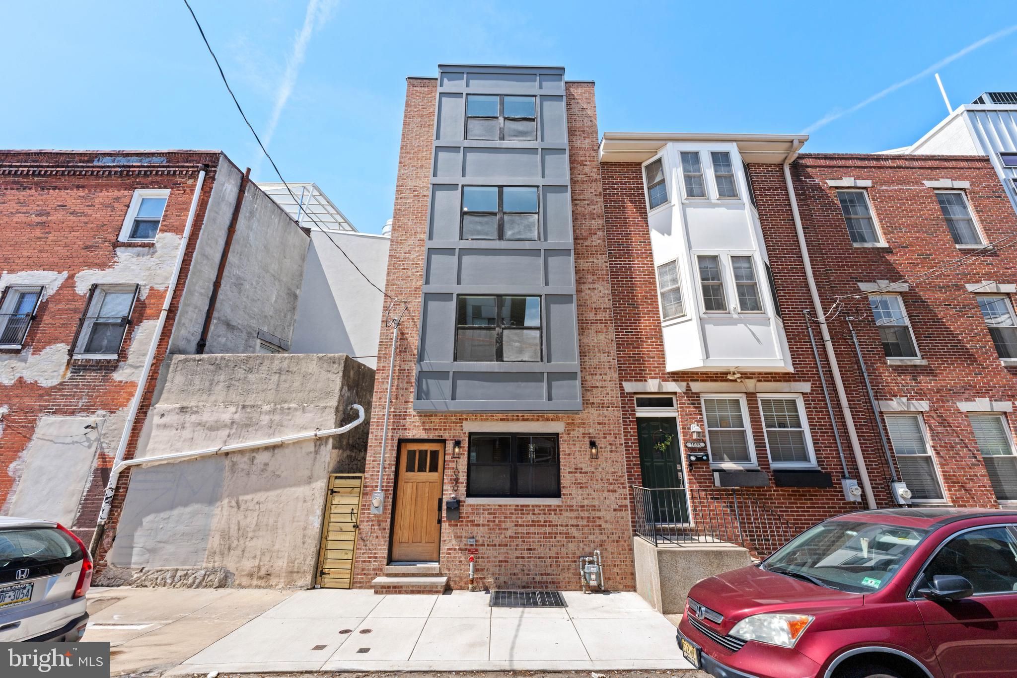 Welcome to 1040 S Randolph St, a stunning 1,800 sq. ft., 4-bedroom, 3-bathroom new construction home located on a picturesque street in Queen Village. This custom-built home offers exceptional craftsmanship and luxurious living, with convenient access to Center City, the Italian Market, and Old City. Step inside to enjoy an open-concept living area featuring engineered hardwood floors and a gourmet kitchen with custom cabinetry and stainless steel GE Café appliances.
On the second floor, you'll find a spacious laundry room, a hallway bathroom with a tub/shower, and a bedroom. The third level boasts a large bedroom with a walk-in closet equipped with built-in storage, and an en-suite bathroom with a beautiful glass-enclosed shower. The fourth floor also features a large bedroom with a walk-in closet with built-ins, and an en-suite bathroom with a beautiful glass-enclosed shower.
The basement offers space for an optional fourth bedroom or an office/entertainment area. This property also includes 2 HVAC units, 10-year tax abatement and a one-year builder's warranty. Don't miss this unique opportunity in vibrant Queen Village.