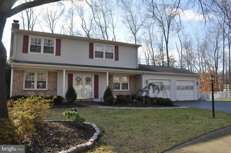 Beautiful Center Hall Colonial. HDW on the main and second level. Kit w/ cherry cabinets, granite, SS app, and eat-in area that opens to fenced yard w/ deck and landscaping. Large LR with wood burning FP. Crown molding and recessed lighting throughout the main level.  LL recreation room w/ wet bar, extra room  for storage. Large extended 2 car garage w/ above garage storage. Sought after schools.