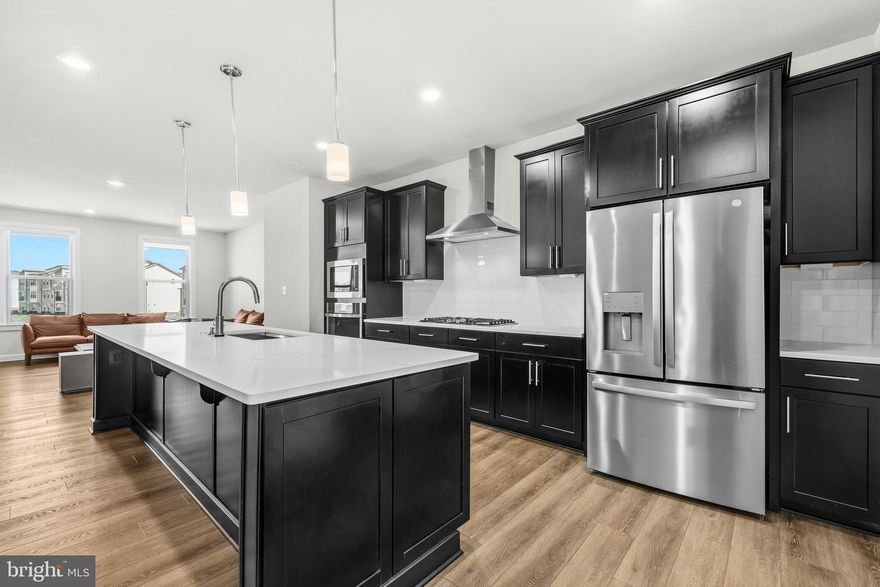 Step inside 103 Green Branch Road and see why this one stands apart. This fully built 2021 NVHomes townhome offers 2,440 square feet of open-concept living in the sought-after Patuxent Greens. Soaring ceilings and natural light set the tone, while the gourmet kitchen with premium finishes flows into the dining and living areas, creating a space built for gatherings and everyday comfort. Four bedrooms, three full baths, and two half baths showcase the craftsmanship NVHomes is known for. The signature feature waits beyond the back door: a covered outdoor living area anchored by a striking stone fireplace, ready for year-round entertaining. The 2-car garage includes an EV-ready charging outlet. Community amenities feature a tennis court, playground, and scenic walking trails, with a future country club, community pool, and fitness center planned. Residents also enjoy access to Greenview Pool, a City of Laurel aquatic facility within Patuxent Greens, subject to facility rules and availability. Commuter-friendly with quick access to I-95, Route 1, dining, and retail. Schedule your private tour and experience it firsthand.