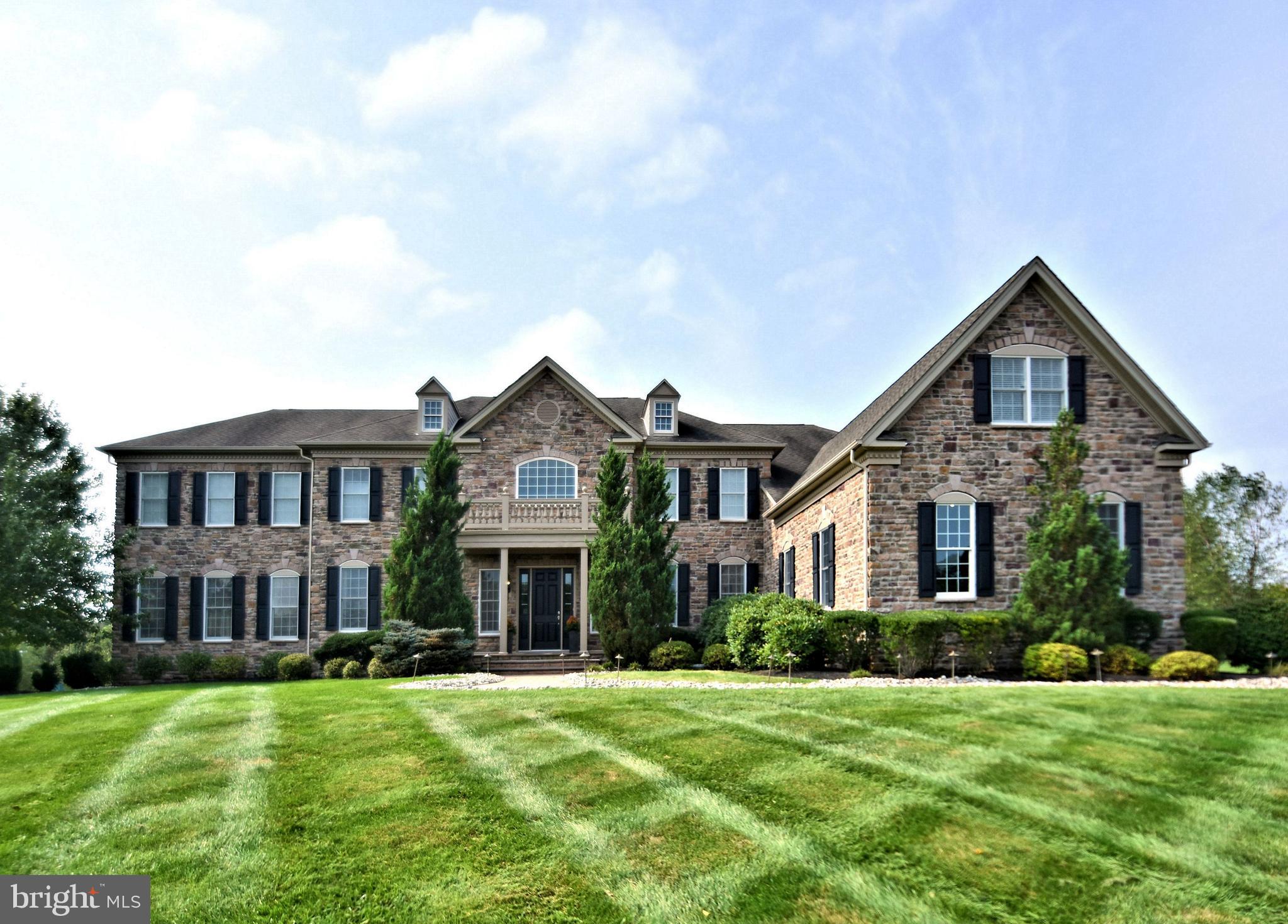 Situated perfectly on an immaculately maintained 1.19 acre parcel sits this spectacular expanded all Stone Front / Hardie Plank Henley model with 6/7 bedrooms, Toll Brothers most popular floor plan. Located in one of Upper Makefield's most sought after and prestigious communities, Dutchess Farm Estates, this home offers the discriminating buyer a wide array of luxury, comfort and construction features and is in mint, turnkey, move-in condition. Enter the soaring two story marble floored foyer, featuring dual curved staircases with wrought iron balusters, and gleaming hardwoods throughout the entire first floor. Impressive 10' first floor ceilings, 9' upper level ceilings, detailed crown, trim, and box moldings are featured throughout this beautiful home. The elegant formal dining room, with tray ceiling is to the right, formal living room to the left. Double doors will lead you from the LR to the giant conservatory, with 11'ceilings, walls of windows on three sides, multiple entertainment/seating areas and gorgeous full-service bar. Bar features include wine cooler, sink, gorgeous cabinetry, and double tiered granite bar top with seating for 6. The gourmet kitchen is a chef's delight, featuring a large triple tiered center island with second sink and seating for 6, upgraded stainless-steel appliances including Wolf 6 burner stove / gridle with full oven and bread oven, stainless range hood, Wolf wall oven and convection/ microwave, Sub Zero 48" side by side refrigerator / freezer, and two Asko dishwashers. Granite counters, 42" cabinets, under cabinet lighting, tumbled stone backsplash, walk in pantry, vegetable sink, tons of cabinet space, desk area, expanded breakfast room with skylights, triple French Doors leading to the rear paver patio, and rear staircase access make this the most spectacular kitchen on the market today. The two-story family room features impressive floor to ceiling stone fireplace (gas) with spectacular box trim millwork ceiling. Perfect for these times are TWO well appointed large private home offices, ideal for all of your Zoom calls and conferences or virtual schooling, laundry/mud room entry w/ built-ins, and powder room complete the first floor. This popular floor plan was designed for maximum entertaining, large holiday and family gatherings, and work/school from home space and privacy. The upper level, with 9' ceilings, features a total of 5 spacious, bright and airy bedrooms, including the Master Suite. The fabulous Master Suite consists of a large sitting room, main bedroom with coffered ceiling, luxurious Master Bath with oversized shower, jetted tub, his and hers large walk in closets ( 3 total ), exercise area, his and her toilettes, his and hers granite counter vanities, and radiant heated ceramic tile flooring. Bedrooms 2 thru 5 are all generously sized and are equipped with private baths, large closets, and ceiling fans. The giant finished lower level features a walk out staircase, Bedroom 6 with attached full bath perfect for guest, in-law or Au Pair, elevated dance floor with mirrored wall, plenty of entertainment and recreation space, additional finished room ideal for gym, music, craft, or 7th bedroom, and ample storage areas. This beautiful Cul-de-Sac lot backs to woods and over 37 acres of preserved space, where you will enjoy incredible Bucks County views and sunsets from your paver patio. The grounds, lawn and plantings are absolutely impeccable. A 4-car garage with painted floor, back-up whole house generator, 6 zone Heat/AC for maximum energy efficiency, security system & much more await you. Located just minutes from Newtown Boro, New Hope Boro and New Jersey Bridges in the heart of Upper Makefield and the Council Rock School District. The home and property, with over 9,500 sq. ft. of finished space, have been lovingly maintained and are offered for the first time by its original owners.