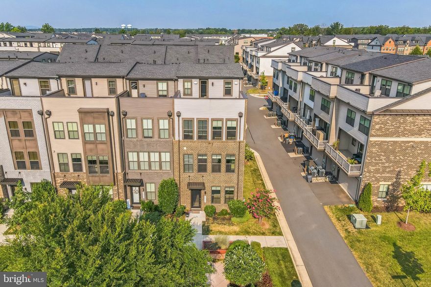 This exquisite 4-level end-unit townhouse in the coveted Westmoore community offers unparalleled luxury and comfort, designed to impress even the most discerning buyer. With an abundance of high-end features and a premium homesite, this home provides the perfect blend of modern amenities and elegant living.

**Fine Features Include:**
End-unit with extra windows | Premium homesite with a garden entrance in the front | Recessed lights with WiFi and color change options | Cat 6 wiring | Ceiling fans in all bedrooms | High-end finishes | Custom Benjamin Moore paint | Custom California Closets organizers | Pre-wired outlets for television mounts in all bedrooms | High ceilings | Sprinkler system | Water Heater (2021) | Designer mirrors and faucets throughout the home.

**Entry Level:**
Upon entering, you'll be greeted by a well-appointed space featuring a bedroom with a full bath. The entry-level layout is designed with a custom bench with coat hooks, and smart locks on both the garage access and front door for convenience and functionality.

**Main Level:**
Elegant oak stairs lead to the main level | Be dazzled by the open-concept living and gorgeous engineered hardwood throughout | Gourmet kitchen boasting granite counters, classic white cabinets, backsplash, recessed lights, pendant lights over the extended island, pantry space with custom California Closets organizers, and stainless steel appliances | Owners extended the cabinetry and counter space by building a wonderful butler’s pantry into the dining room | Convenient powder room | Enjoy the covered balcony/deck, complete with a cozy gas fireplace, perfect for relaxing in any season.

**Upper Level 1:**
This level is dedicated to rest and rejuvenation | High ceilings along with top-of-the-line upgraded carpet and padding | It features three generously sized bedrooms, each designed with comfort in mind | The owner's suite is a true retreat, offering a spa-like bathroom with recessed lighting, ceiling fan, and a custom California Closets organizer in the walk-in closet | Two additional bedrooms feature recessed lights, ceiling fans, custom organizers, and share a well-appointed hallway bath | The conveniently located laundry room on this level adds to the home's practicality and ease of living.

**Upper Level 2:**
Includes a versatile loft area, which features a bar with a beverage refrigerator, sink, and a surround sound speaker system that will convey with the home, including subwoofer, speakers, and receiver | Additionally, there is another spacious bedroom with a large closet and an expansive bathroom | Step out onto the rooftop terrace to enjoy serene views and peaceful outdoor relaxation | The rooftop has a gas line for your firepit or grill.

**Community and Location:**
Westmoore offers an array of amenities, including two large parks, an amphitheater, a dog park, a community pool, a clubhouse, a fitness center, and numerous walking/jogging trails | Lawn maintenance is included in the HOA, ensuring a hassle-free living environment | The location is unbeatable – just 1/2 mile from the Ashburn Metro, minutes from the Dulles Greenway, and close to stores, shops, and restaurants at Broadlands Marketplace | Plus, it’s only a 10-minute drive to Dulles Airport.

Don’t miss the opportunity to make 22350 Lucas Terrace your new home. Experience the best of Ashburn living with the perfect combination of modern amenities, a welcoming community, and a prime location. Contact us today to schedule a viewing and see for yourself why this end-unit townhouse is the perfect place to call home.