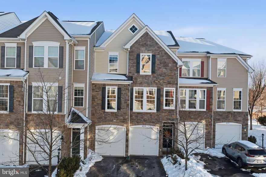 “Always choose the room with the view—life is better when you can see what’s possible.” This townhome has it all: 3 bedrooms, 3 1/2 baths with approximately 3000 square feet of living space, and a beautiful view from every room. This home overlooks a lake and is filled with sunlight.  The open-concept main level features a gourmet kitchen with granite countertops, stainless steel appliances, including double wall ovens, and a large center island that leads to a cozy living room with custom built-ins and a gas fireplace. It also leads to one of two outdoor decks - perfect for watching the evening sunset. In addition, the main level includes an airy and open dining room, a private office, and a half bath. Upstairs, the primary suite offers two walk-in closets, a lovely bathroom with a soaking tub and oversized shower, and its own deck perfect for morning coffee. Two additional nice-sized bedrooms, a second full bathroom, and the laundry room complete the upper level. The lower level includes a versatile recreation room and a full bath—ideal for guests or a home office.  A two-car garage and excellent curb appeal round out this exceptional home. Just a 5-minute walk to the Brambleton’s shops, dining, and entertainment, and zoned for the highly sought-after Waxpool ES * Eagle Ridge MS * Briar Woods HS pyramid, this home blends comfort, style, and community in one unbeatable package. Make this YOUR home!