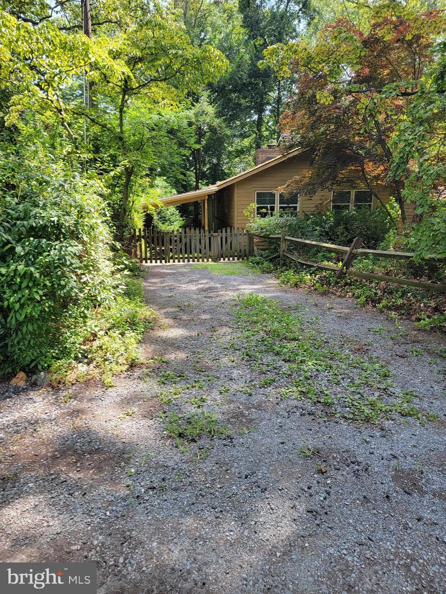 Bring your imagination. This home has so much to offer once you look pass its current condition. Lets start with the yard. At one time there were gardens all about. Currently overgrown and needs some love. What is still there is a path and stairs to the right of the property that take you right down to the fabulous community beach on the Severn. Wow!! This property has a gate that will take you right to the path. (easy to see from road to beach) There is a shed that needs removed and a wooden garden building that may be worth fixing up. There is a carport and room for 1 or 2 more cars in driveway. There is a wrap around deck (on two sides) with the largest part overlooking the back yard. Wonder if there is a peak of a water view when all is cleaned up? Inside has 2 bedrooms, full bath, living/dining with a wonderful fireplace with woodstove insert and of course the kitchen. Open stairs take you to the basement with another fireplace and laundry. This home is being strictly sold 'As Is".