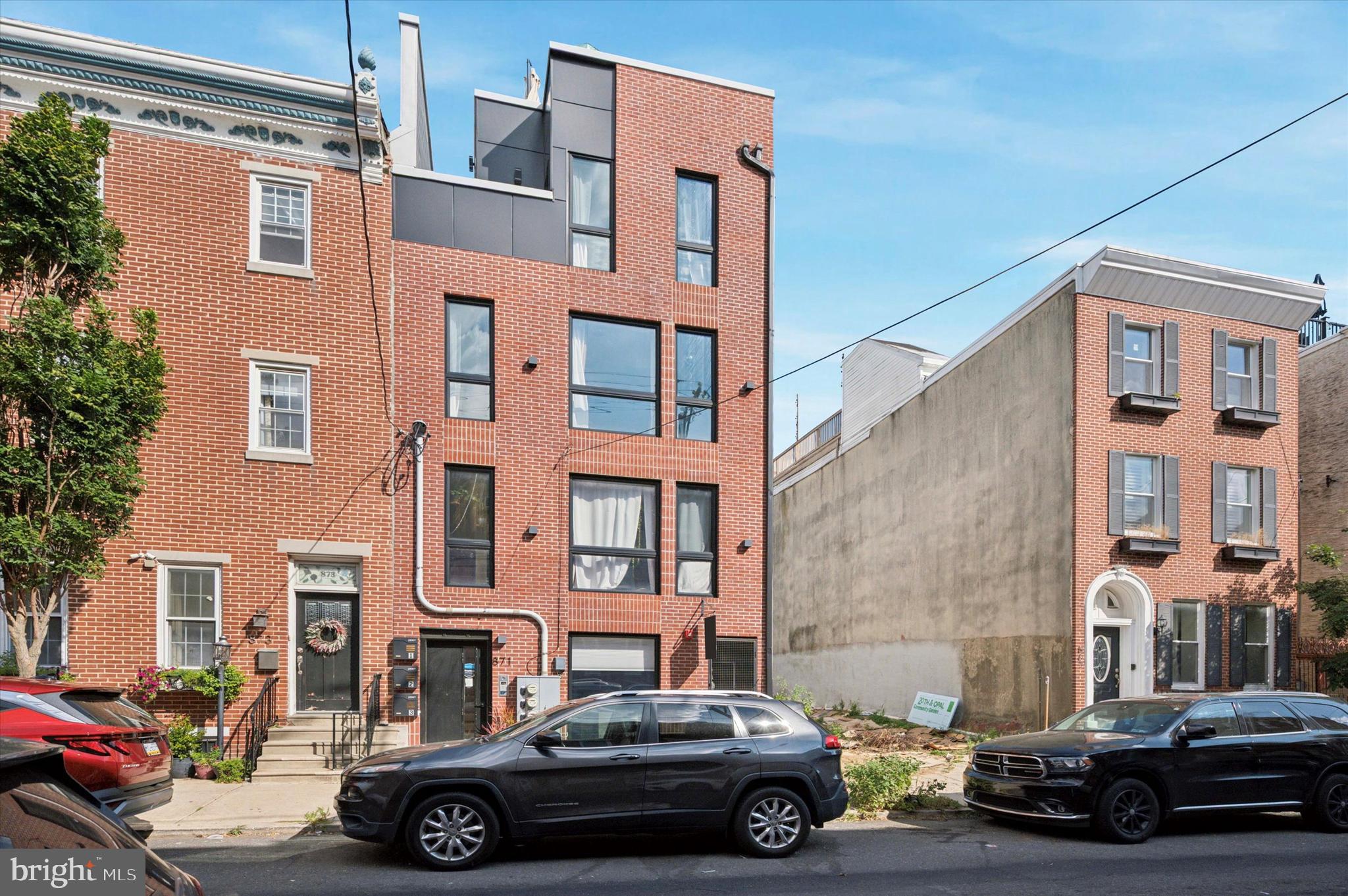 Welcome to 871 N 20th Street w/ DEDICATED PARKING for under $550k! This 3 year young building with high-end luxury finishes consists of 3 condos and is located in the heart of the Francisville/Fairmount neighborhood. Upon arrival into Unit 1 you will immediately notice the spacious main level floor plan featuring the stunning chefs kitchen and the open living area. The chef's kitchen features stainless steel appliances, white quartz countertops, tons of cabinetry for kitchen storage and a large island with room for barstool seating. Off of the kitchen is the open living area with pristine hardwood flooring and recessed lighting throughout. Towards the rear of the home is the first bedroom & bathroom duo. This bathroom features high end finishes and designer tile. The rear of the home also gives access to the outdoor parking spot, designated for Unit 1. Down the steps, is the laundry closet with washer & dryer, primary bedroom & stunning full bathroom. The primary bedroom features tons of space, recessed lighting and custom shelving for clothes. The bathroom features an LED mirror with dual vanity sink with storage for bathroom necessities. The shower has glass doors with gold accent fixtures, a shower niche and tons of space. This luxury condominium comes with 7 years remaining on the tax abatement! 871 N 20th Street is in close proximity to The MET Philadelphia, Eastern State Penitentiary and steps from all that Fairmount Avenue has to offer. Schedule your tour today!