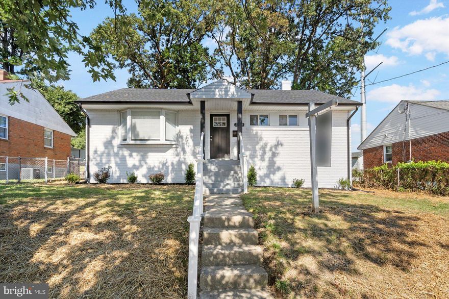 Adorable, newly remodeled 4BR/2BA Rancher located on a tree-lined street in Hyattsville.  A newly whitewashed brick exterior accented with black trim welcomes you to the covered front entry of your forever home.  Step inside to a bright open concept floor plan offering wide plank hardwood flooring throughout the entire main floor.  A spacious living room with a beautiful accent wall hosting an electric fireplace is open to the gorgeous kitchen, allowing for the ideal entertaining space.  The kitchen boasts plenty of two-tone cabinets, quartz countertops with a subway tile backsplash, and stainless steel appliances.  The main floor hosts three of the four bedrooms, including a spacious primary, and a full bath.  An open staircase leads to the newly carpeted lower level offering additional living space along with the fourth bedroom, a full bath with walk-in shower, storage, laundry, and a walk-out to a spacious yard.  From the kitchen step out onto a newly constructed wood deck that overlooks a yard filled with green space, adult shade trees, and tons of possibilities.  This home is move-in ready with so much to offer new homeowners and is located in close proximity to shopping, restaurants, and commuter routes.