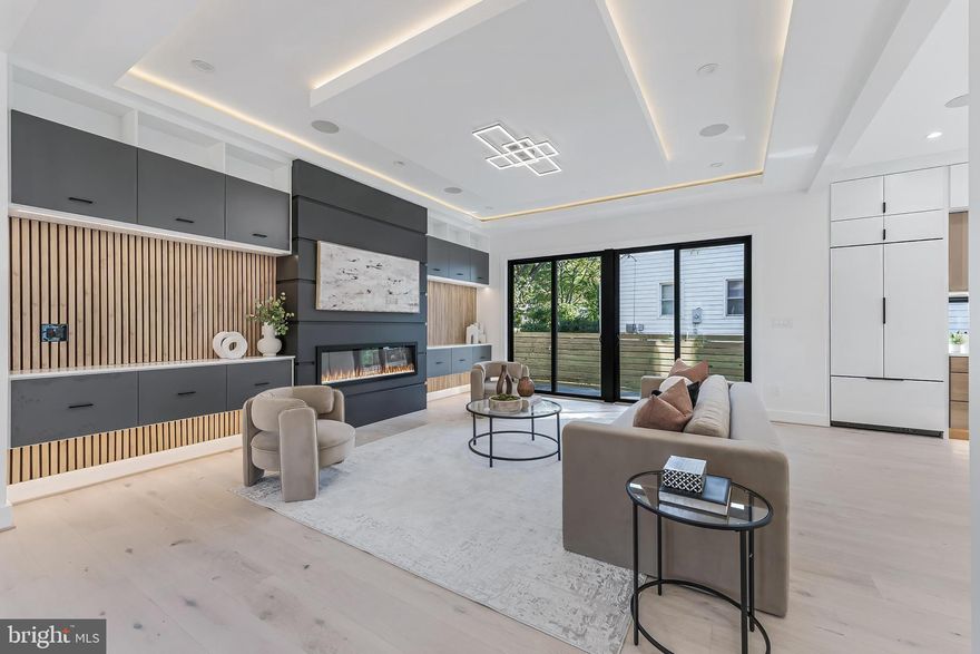 **Ask for a Private Tour, Terms Apply*Welcome to this one-of-a-kind dwelling which blends mid-century exterior form with modern interior design.  It was designed by Axis Architects and backed by a Builder's Warranty.  This striking 5,600 SqFt custom build is situated on  1/3-acre premium, fenced corner lot, with a 400 SqFt apartment loft atop the detached garage (22'x20').  It spans 3 levels with 5 bright bedrooms and 5 luxurious baths (main house).  Garage parking for 2-cars, plus 4-car driveway, and 6-car curbside!  This home features an unrivaled open-concept plan perfect for modern living and entertaining. The stunning living room boasts 10-ft inverted tray ceiling with LEDs, Bluetooth ceiling speakers, fireplace accent wall, and deck access.  The gourmet kitchen features 10-ft waterfall quartz island, JennAir stainless appliances, two-tone cabinetry, walk-in pantry, and sgd to a second Trex deck.  On the main level, there is also an office, bedroom, and full bath.  Next to the dining area is a side door that leads to the mud room with a built-in bench and a pet washing station. A dramatic floating staircase with a corner wall of windows leads up to the vaulted family room with 15-ft ceiling height, skylights, and balcony access door.  The primary suite features floor-to-ceiling windows, luxurious soaking tub and shower, walk-in closet, dry bar, and private access to the balcony. Two other ensuite bedrooms and a separate laundry room complete the upper level. The open basement boasts a large recreation area, gym, wet-bar, ensuite bedroom, and walk-up stairs to the rear yard. The Bel Air neighborhood is tucked away yet minutes from major highways, I-495, I-66, Rt 50, East Falls Church Metro, and key destinations, such as, the Mosaic District, Tyson's Galleria, and Inova Fairfax Hospital.