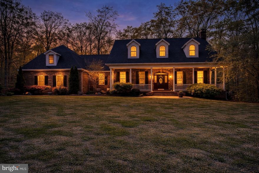 Timeless craftsmanship meets modern comfort in this one-owner, custom-built retreat on a private two-acre lot, just blocks from the Town Square and with no town taxes. Nestled on a quiet cul-de-sac, the home welcomes you with an expansive front porch perfect for drinking a cold iced tea and enjoying the relaxing swing or the outdoor seating overlooking a lush, mature lawn. The thoughtfully designed floor plan features four bedrooms and 3.5 baths, with a first-floor primary suite and spa-like bathroom for easy single-floor living, while generous upstairs space offers flexibility for family, guests, or a home office. Inside, hardwood floors flow throughout, a bright chef-inspired kitchen with a large pantry and new appliances (including a dual-fuel cooktop) supports everyday cooking and entertaining, and full-house surround sound and hard-wired smoke alarms add convenience and peace of mind. Practical features include two executive staircases, a large bonus room adaptable to a studio, gym, or extra bedroom, walk-in storage, two hot water heaters for efficient distribution, dual-zone HVAC, and an unfinished rough-in area ready for your personal touch. Outside, enjoy an entertainment area, deck with hot tub, and a backyard that borders a peaceful creek—plus no HOA so you can truly make the property your own. An appraisal confirming the home’s strong value is available upon request.