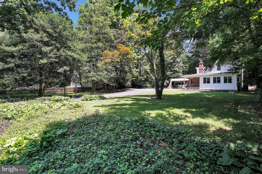 Absolutely stunning renovation!  Welcome to your meticulously updated home in Silver Spring boasting over 2400 square feet of living space nestled in a peaceful, oversized half acre with a park-like setting.  Sitting back from the road amidst its expansive and rare half acre parcel, this property features a long private driveway, ample guest parking, and a mid-century covered carport.

Inside, modern elegance defines the living space with gleaming hardwood floors with a spacious hosting area flooded with light. Designed for both relaxation and practicality, the main level includes a mudroom woven with interior brick, ceiling beams leading to the seamlessly connected gourmet kitchen boasting its open concept, stainless steel appliances, granite countertops, and contemporary cabinetry.  Still on the main floor, the back of the house holds one of the home’s two master bedrooms, a half-bath for guests, and a living room built to showcase the stunning hardwood floors.  Pass through the sliding glass door for access to the deck, patio, and sprawling backyard!

Up the newly exposed modern staircase, the primary master bedroom steals the show.  Three closets including a walk-in, a newly renovated en suite bath, and brand new French doors leading to your private deck access.  Spread the doors open and watch the snow fall from your bed.  Moving down the hall you’ll find two additional generously sized bedrooms accompanied by yet another full bath with hall access.

The fully finished lower level offers flexibility with space for an office, gym, or recreation room, featuring new carpeting and French drains. Outside, mature landscaping enhances the serene backyard oasis including an in-ground fire pit. With a total of 4 bedrooms, 3.5 baths, a fully finished basement, and a brand new roof, this home provides ample room for the entire family. Ideally located near grocery stores, dining options, parks, and just a mile from the Forest Glen Metro, this residence offers a perfect blend of comfort and convenience.