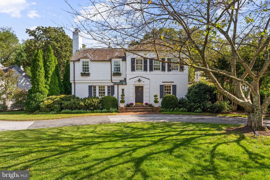 Gracious and effortless living in Westmoreland Hills. Set on a verdant and park-like 13,000+ square foot lot in one of Bethesda’s most coveted neighborhoods, 4509 Wetherill Road captures the refinement of classic architecture with the ease of a modern lifestyle. The circular drive is hugged by mature plantings, flowering gardens, and a welcoming white-washed facade. The home is framed by trees and lawn like a private park, hinting at the thoughtful design, architectural details, and designer finishes within.

A classic center-hall plan welcomes you with hardwood floors and decorative millwork, and expansive sight-lines that draw the eye toward the kitchen and gardens beyond. The oversized formal living and dining rooms set the tone with fireplace, crown moulding, and statement lighting. The kitchen reveals itself as the soul of the home, a space designed with both imagination and intent. The oversized island is perfectly proportioned for cooking and conversation. A breakfast banquette glows with natural light. Designer lighting adds subtle drama, and the open connection to the family room makes daily living both seamless and elevated. For added convenience, a home office with built-ins allows for remote work adjacent to the action. A perfectly appointed powder room completes the main level.

Upstairs, four bedrooms and three baths create a private and intuitive layout. The primary suite is the highlight, a retreat that blends scale and comfort, with ample natural light, a magazine-worthy walk-in closet, and a warm setting that brings calm to the busiest of days. The en suite bath offers marble and tile chosen with care, a furniture-like dual vanity, a soaking tub, and a walk-in shower that together evoke the refinement of a luxury hotel. It is a sanctuary, both restorative and inspiring.

The three additional bedrooms are spacious, filled with light, and designed for comfort. The designer fixtures and statement lighting of the two other bathrooms, along with the wainscoting, sconces, and custom carpeting, evoke the charm of a New England bed-and-breakfast.

The lower level extends the lifestyle with a flexible recreation room for gatherings, another full bath, a bedroom for guests or an au pair, laundry, storage, and direct access to the two-car garage.

Out back, a spacious screened-in porch spans the rear of the home, providing additional dining and entertainment spaces that connect easily to the beauty of the landscape. The verdant lot unfolds like a private park, with layered plantings, mature trees, and natural topography that lifts the home to overlook the sweeping yard. With over 13,000 square feet, the possibilities are endless. Picture a pool or sports court, a gazebo tucked among the trees, or celebrations under a tent. Summer evenings invite fireflies, s’mores, and laughter that drifts into the night.

Westmoreland Hills, and more specifically this quiet, non–cut-through street, amplifies a peaceful life just steps to the shops and restaurants of Spring Valley in D.C. Near Capital Crescent Trail, Little Falls Park, and Westmoreland Park, major commuter routes to downtown DC, northern Virginia, and downtown Bethesda. Westbrook, Westland, B-CC schools serve the neighborhood.