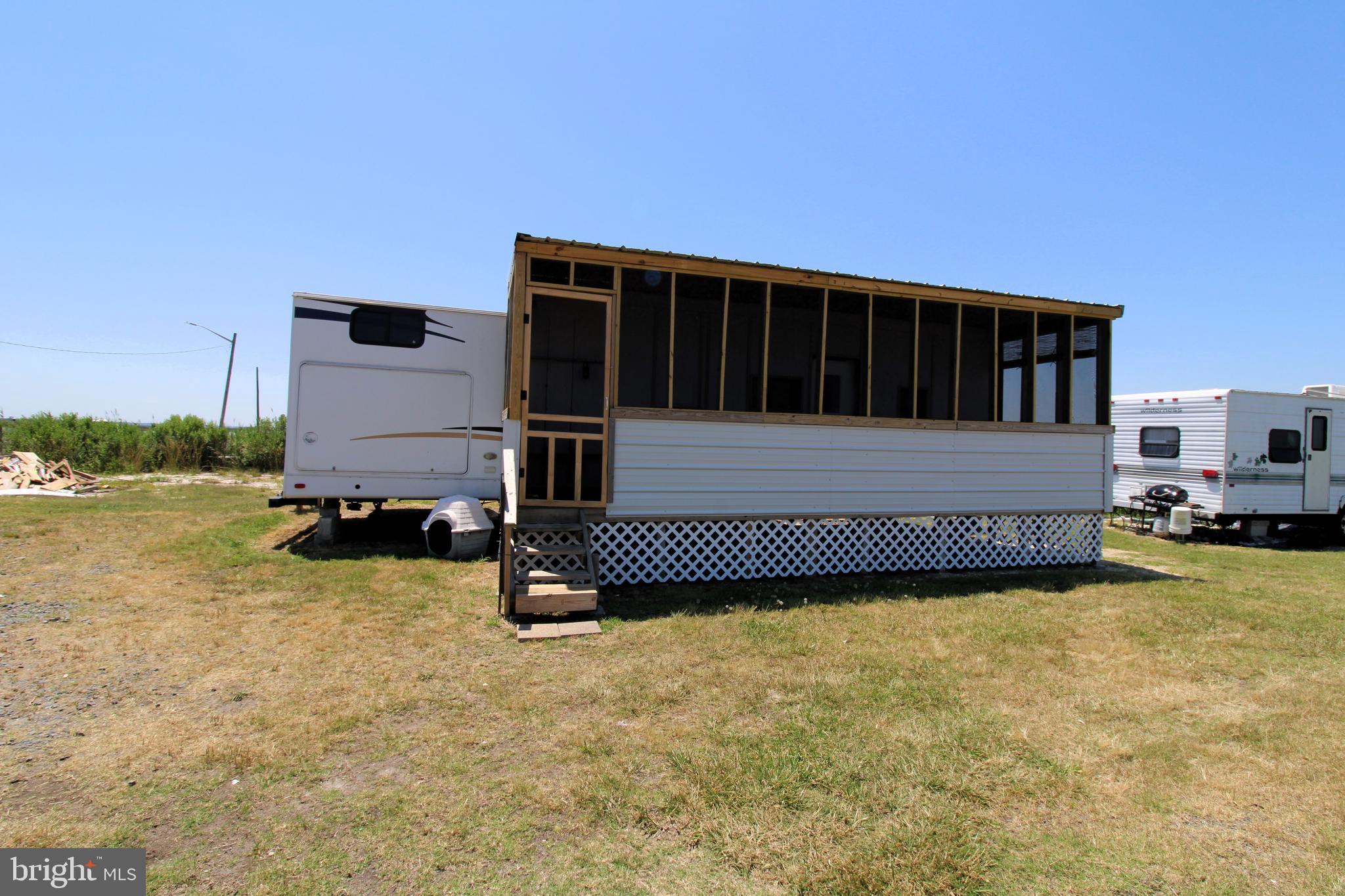 Waiting release of contract. Sleeps 4 to 6 and has a large screened entry porch for relaxing and staying out of the elements, but enjoying the views and camp ground. Body of water is Monokin River with the best fishing on the Eastern Shore. Just 8 miles to open bay and 30 miles to Solomon's Island. Park is open from April 1 to Dec 1. Park amenities include water, sewer, lawn care, and trash pickup - all for a hassle-free stay. Quick Move-In: Start unwinding the moment the transfer is complete. No delays, just pure relaxation. Additional Information: Price: $3,500. Lot rent starting April 1st 2025 covers water, sewer, trash removal and lawn care. Park Approval: Ensure a smooth transition by securing park approval for lot lease.
Unwind by the Bay! Your Perfect Vacation Retreat Awaits Escape to your own slice of paradise with this charming vacation home, being sold AS IS. Forget worries and indulge in the ultimate bay experience - whether it's fishing, crabbing, kayaking, crabbing, boating or simply soaking up the sun. Features & Amenities: Unmatched Value: At this price, experience waterfront living without breaking the bank. Prime Location: Just steps away from the water's edge, with a public boat ramp across the street for easy access. Endless Recreation: Enjoy fishing, crabbing, water skiing, boating, jet skiing, kayaking, and canoeing - right at your doorstep. Kick back on the screen porch and savor stunning sunsets over the bay. Dining & Entertainment: Indulge in delicious meals and live music at nearby Pit & Pub and TIKI Bar & Grill, just across the street at the marina. Convenience: Verification: Buyers and agents are encouraged to verify all listing information, including park approval and lot rent. Don't Miss Out! Call Now for Your Appointment. Experience the joys of bay life without delay. Your perfect getaway awaits - seize the opportunity today!