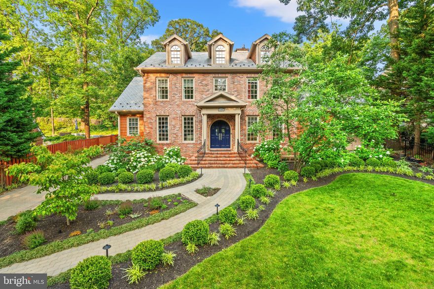No detail has been overlooked in this stunning residence. Built in 2008 and recently updated throughout, this gracious center hall/antique brick Colonial boasts over 6,000 square feet of living space spread across four floors. The flexible layout includes five- six bedrooms, including an in-law/nanny suite on the lower level with a private entrance.

The main level features a primary suite with deck access, one of three primary suites in the home. The walk-up lower level offers a covered outdoor patio, a space that could be used as a gym, a game room, wine cellar, English pub bar with a full kitchen application, gas fireplace, private nooks, a second bedroom, a full bath, and a second laundry area. There is potential for another suite on this level. 

Upon entering the home, you are greeted by a quiet parlor/library and a grand dining room. Moving further inside, you'll find the heart of the home: a gathering great room with a gas fireplace and coffered ceilings. The kitchen is equipped with premier appliances, butler's and storage pantries, and an oversized island that is both beautiful and practical.

The upper level includes three spacious bedrooms, all ensuite. The third primary bedroom is particularly impressive, featuring an oversized layout with a sitting area, a gas fireplace, and an opulent spa-like bathroom with a soaking tub, separate steam shower, double sinks, two walk-in closets, as well as convenient additional laundry. The second and third bedrooms have ensuite baths, A staircase leads to the top-level flex space, which would be ideal for a home office, playroom, or another bedroom.

The property features a paved driveway leading to an oversized two-car garage. The private outdoor deck is easily accessible from multiple points, enhancing the great entertaining floor plan throughout the home. Additionally, the roof is made of long-lasting slate and there's a vegetable garden!

Located conveniently close to several schools, including MVCS, St. Stephens/ St. Agnes Lower School, and Alexandria Country Day School, this home also offers easy commutes to DC and Old Town Alexandria. Just 2 short miles to Reagan National Airport (DCA)!
