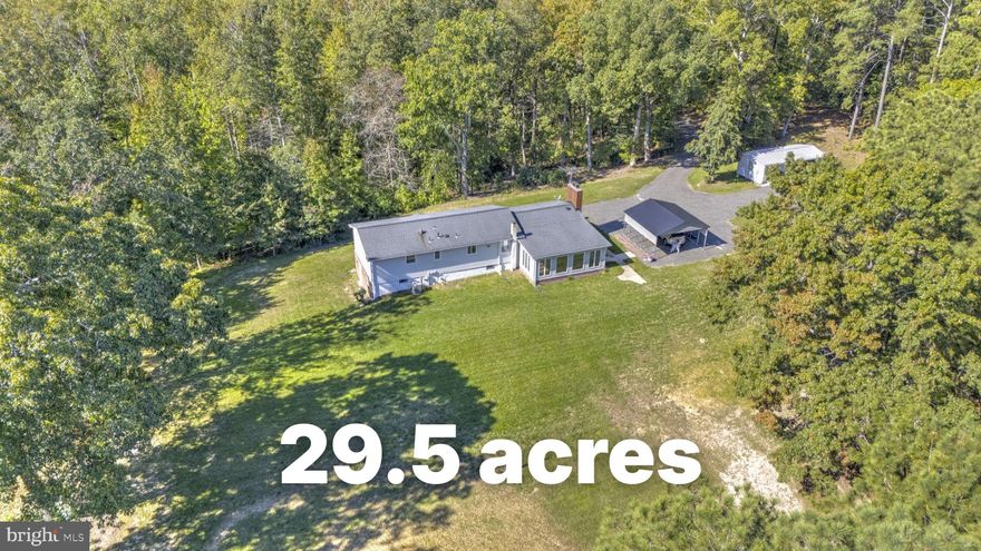 Nestled on 29.5 acres of serene, wooded privacy, this exceptional estate offers a rare blend of character, modern updates, and endless potential. Inside the 2,700+ sq ft home, you’re welcomed by distinctive features like a striking cedar beam and dual staircases that add warmth and architectural charm. The spacious kitchen is a standout, featuring granite countertops, stainless steel appliances, tile flooring, and abundant cabinetry—perfect for both everyday living and entertaining.

The home offers generously sized bedrooms, an updated guest bath, and a luxurious owner’s suite complete with a walk-in closet and a beautifully renovated en-suite with floor-to-ceiling tile and a walk-in shower. The main level provides multiple gathering spaces, including a formal dining room, a large family room, and a unique all-season room filled with natural light.

The finished basement expands your living space with a cozy wood stove, three additional bedrooms, and a fully updated bathroom—ideal for guests or flexible living needs. Outside, two open field areas offer endless opportunities for recreation, gardening, or even horses, while the detached workshop with its own 200-amp service is perfect for hobbies, storage, or projects.

With major updates including a newer roof, HVAC system, well pump, and hot water heater, this home offers peace of mind along with its natural beauty—all just minutes from shopping, dining, and Pax River.