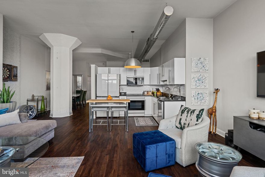 Unit 515C at Marine Club is a spacious and sleek lofted unit that stands out as one of the few larger options in the building. With over 900 square feet of living space, it offers a generous layout that includes an open living and kitchen area, a separate dining area, a roomy lofted bedroom, a large marble bathroom with a separate shower and jetted soaking tub, a spacious laundry room, and ample closet space.

The kitchen is a standout feature, equipped with Samsung Bespoke Series appliances, black Corian countertops, and a subway tile backsplash. Oversized north-facing windows offer views of the central courtyard and provide bright, indirect lighting throughout the space.

Marine Club offers a range of community amenities to enhance the living experience. Residents can enjoy a 24/7 front desk, a large onsite fitness center, and a central courtyard with a koi pond, seasonal lounge area, and dog play area. The building’s reasonable fees and taxes make it an attractive option for those seeking convenience and access to various amenities.

Marine Club’s location is a major draw. Grocery stores, retail shops, and public transit options are all within a short walk, making it easy for residents to get around. The building is also close to Center City and many popular South Philly neighborhoods, including Graduate Hospital, Newbold, Bella Vista, Passyunk Square, and East Passyunk.