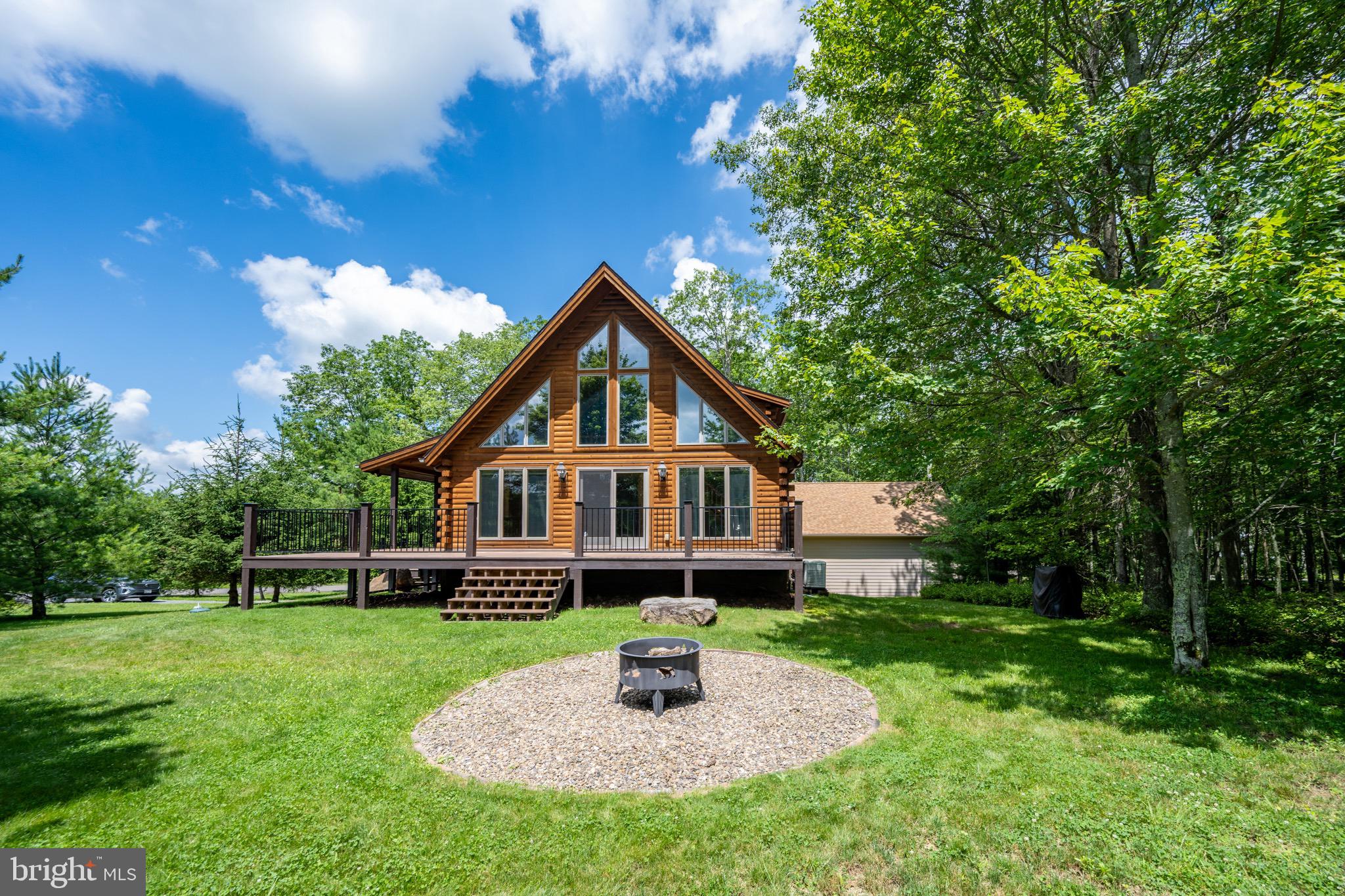 $30,000 price reduction! Looking for the ultimate mountain cabin getaway? 45 Deer Crest Court may be your answer! This Mountaineer Log Home offers many of the premium finishes you are looking for, and is one of the most well kept homes on the market in this price range. Offering 5 bedrooms, 3.5 bathrooms, 3 levels of living and 2968 square feet of interior living space, this home has plenty of room to gather year-round. Each level has a common living space, providing plenty of area to expand throughout the home. The main level offers a primary bedroom suite. Upper level offers 2 bedrooms, 1 full bath and a balcony/office space, and the lower level offers 2 more bedrooms, 1 full bathroom and movie room/rec space. Each bathroom in the house offers the comfort of heated floors. The outdoor deck space provides plenty of room for outdoor entertaining in the summer months, and wooded perimeter offers an enhanced private feel on the 1.41 acre lot. Enjoy the perks of a recently built 2-car, detached garage, paved driveway and backup generator! Recently added new GE appliances with extended warranties. The private setting is just minutes to most main attractions of the lake area, the Deep Creek State Park, boat ramp, and only 15 minutes to Wisp Resort! If you are looking for a well kept home that encompasses many of the essential living necessities you are looking for here at the lake, this home may be worth scheduling to see. Call today to schedule your own private tour of this incredible property!