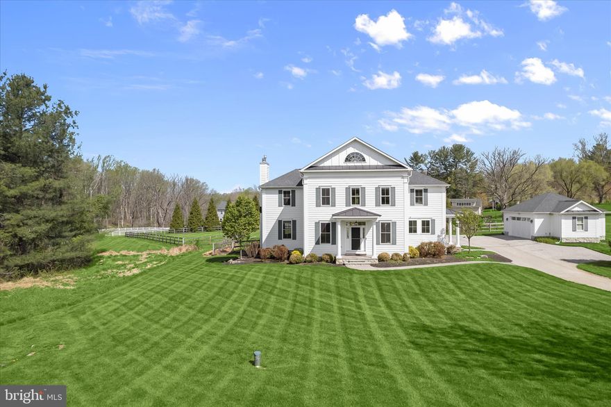 Tucked away on a meticulously manicured two-acre lot in a private enclave off Cuba Road, this exquisite residence offers a blend of privacy, sophistication, and thoughtfully curated design. Featuring four bedrooms with four and a half bathrooms, the home is filled with natural light, complemented by a refined neutral palette, high-end finishes, and exceptional attention to detail throughout. Step inside the two-story foyer where rich hardwood floors greet you, enhanced by elegant wainscoting and crown molding that add a polished touch. Sliding pocket doors open to a main level office with a walk-in closet, creating a quiet and versatile workspace. Designed for both everyday living and entertaining, the open-concept main level showcases designer lighting, tall beamed ceilings with integrated speakers, and automatic window shades that adjust with the sunrise and sunset. The gourmet kitchen is beautifully appointed with granite countertops, a tile backsplash, center island with seating, walk-in pantry, and tall soft-close cabinetry. High-end stainless steel appliances include a Jenn-Air six-burner range with griddle and double ovens, a built-in range hood, and a recently replaced Miele dishwasher. Just beyond, the mudroom serves as a convenient drop zone from the side entrance, offering ample storage, while the separate laundry room features a brand new stacked washer and dryer with a sink. The spacious dining room with sliding glass doors outside provides an ideal setting for gatherings, while the cozy family room is anchored by a wood-burning fireplace. A half bathroom completes the main level. Upstairs, the primary suite serves as a true retreat with a gas fireplace, walk-in closet, and a luxurious bathroom boasting a dual-sink vanity, freestanding clawfoot tub, and frameless walk-in shower. An expansive loft offers flexible space for a lounge, office, or additional living area. A second bedroom suite includes its own walk-in closet and private bathroom, while the third and fourth bedrooms share a well-appointed hall bathroom. Downstairs, the fully finished lower level features a spacious recreation room with plenty of room for a variety of activities, along with a walk-in closet and a fourth full bathroom. A utility room provides additional storage space. Outdoor living is equally impressive with a large covered patio equipped with outdoor speakers. The fully fenced, level backyard has ample space for outdoor enjoyment. Additional highlights include a two-car garage with two 240-volt outlets for EV chargers, dual-zoned heating and cooling systems, a whole-house generator, indoor sprinkler system, water filtration system with a neutralizer and ultraviolet light, and a zoned speaker system. Some images have been virtually staged.