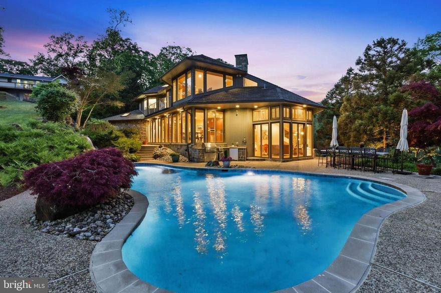 REDUCED $250K FOR THE MOTIVATED BUYER TO ENJOY THEIR PRIVATE RETREAT IN TIME FOR A FABULOUS SUMMER STAYCATION!!  Discover your own private waterfront paradise in this exceptional 6-bedroom, 5.5-bathroom home that feels like a year-round luxury resort.

From the moment you arrive, expansive water views greet you from every room, inviting natural light and serenity indoors and out. The home's prime private lot faces west, offering breathtaking sunsets that paint the sky in vibrant hues—perfect for unwinding after a day on the water.

Step outside to an entertainer’s dream backyard: a saltwater heated pool with cascading waterfalls for refreshing swims, a relaxing hot tub tucked into beautiful landscaping and hardscape, and a full outside kitchen right by the pool for effortless poolside gatherings. A sandy beach invites barefoot strolls, while the wildlife—playful ducks and turtles—adds a touch of natural charm to your daily life.

At the water’s edge, your private pier features 8+ MLW depth and multiple slips accommodating four or more boats, complete with electricity and water. Whether you’re boating, fishing, or simply enjoying the views, this setup delivers unmatched convenience and fun.

Inside, the chef’s kitchen impresses with premium appliances including a double oven, induction stove, trash compactor, built-in microwave, warming tray, and abundant cabinetry for all your storage needs. Two dramatic floor-to-ceiling wood-burning fireplaces create cozy, inviting focal points for family nights or elegant entertaining.

With so many thoughtful features and endless opportunities for waterfront living, this home offers a lifestyle that’s hard to find and impossible to forget. It’s truly a must-see property—schedule your private showing today and imagine making this dream your reality.