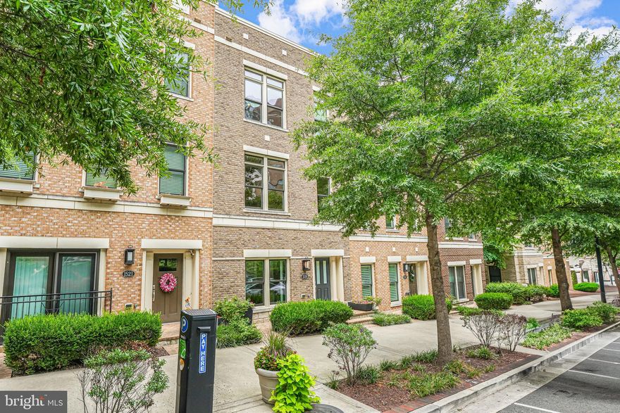 Welcome to this exquisite townhome, crafted by Madison Homes in 2016 and nestled within the exclusive Rosslyn Key community. With 2,345 sq ft across four levels, this residence features a private elevator for easy accessibility, along with a rear entry, attached two-car garage. Throughout the home, high ceilings adorned with 3-piece crown molding create an elegant ambiance. The large aluminum clad windows with Low-E glass provide plentiful bright light. The dual zone heating and cooling system has been meticulously maintained by the original owners.

Enter the ground level and walk into a welcoming foyer with hardwood flooring. To the left, behind glass French doors, there is a bright private space perfect for a home office or family room, with a half bathroom on this floor as well as access to the attached garage. Up the stairs, or by elevator, on the second level you reach the heart of the home which continues the hardwood floors through the open plan living room, dining room, and kitchen. The gourmet island kitchen is well-equipped with top-tier Thermador appliances, including a paneled refrigerator and dishwasher. A private deck off the kitchen opens the space with room for a table and grill.  There are electronic window treatments in key areas on this level to ensure privacy and light control for the many windows.

The third level has the luxurious primary suite with ample closet space and custom storage solutions,  and a roomy en suite primary bathroom with a large tiled glass enclosed shower. This level also has a secondary bedroom with a private en suite bathroom and walk-in closet. The topmost level offers a third bedroom with plush Masland carpet and en-suite bathroom, flex space, and access to the home’s private rooftop terrace. The rooftop deck overlooks the front of the home with room for conversational seating and is perfect for outdoor entertainment.

This home was designed with accessibility in mind. It features a ramp to the front door for easy access, doorways that meet requisite standards, and an elevator that services all levels.

Conveniently located in Rosslyn, this home is surrounded by many vibrant dining and shopping options. It's just a short distance to Georgetown and the Rosslyn metro station (0.3 miles), providing easy access to major commuter routes such as Rte 50, GW Parkway, I-66, and Langston Blvd. Reagan National Airport is also conveniently nearby. Experience luxurious urban living at its finest in this meticulously maintained townhome. Schedule your private tour today!