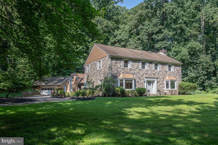 Enjoy the tranquility and convenience of this gorgeous 5 bedroom, 3 full and 1 half bath Wynnewood home.  Sitting on a wooded 0.94 acre lot with stream, at the end of a cul-de-sac, this 4025 square foot home is flooded with sunlight and offers serene views from every window.  The center hall leads to the spacious formal living room with beautiful random width hardwood floors that continue throughout, marble surround wood burning fireplace and bookended by bay window and sliders to back patio.  The formal dining room also with large bay window features crown molding, chair rail and built-ins, and is located just off the kitchen perfect for hosting dinner parties.  The spacious kitchen with ceramic backsplash, granite countertops, breakfast bar with 2nd sink, and stainless steel appliances offers ample counter space and storage and is open to the cozy family room and breakfast room with skylights and sliders to back patio and pool area.  Work desk, pantry, laundry and half bath complete this space. Off the side entry is the sizeable, airy 1st floor ensuite, with vaulted ceilings, skylights, sliders and full bath with double vanity ideal for in-law/au pair suite.  Ascend the open curved staircase to the 2nd floor where you will find the 2nd main bedroom also with vaulted ceiling and skylights, walk in closet and full bath with double vanity.  Three additional bedrooms, hall bath and access to the walk-up attic with tons of storage finishes this level.  The finished basement provides additional storage and living area for home office, workout space or play/game room.  Step outside and enjoy the sounds of nature or take a stroll to Suburban Square’s shops and restaurants.  Located in the award winning Lower Merion School district and close to everything, this home is the perfect balance of accessibility and harmony.