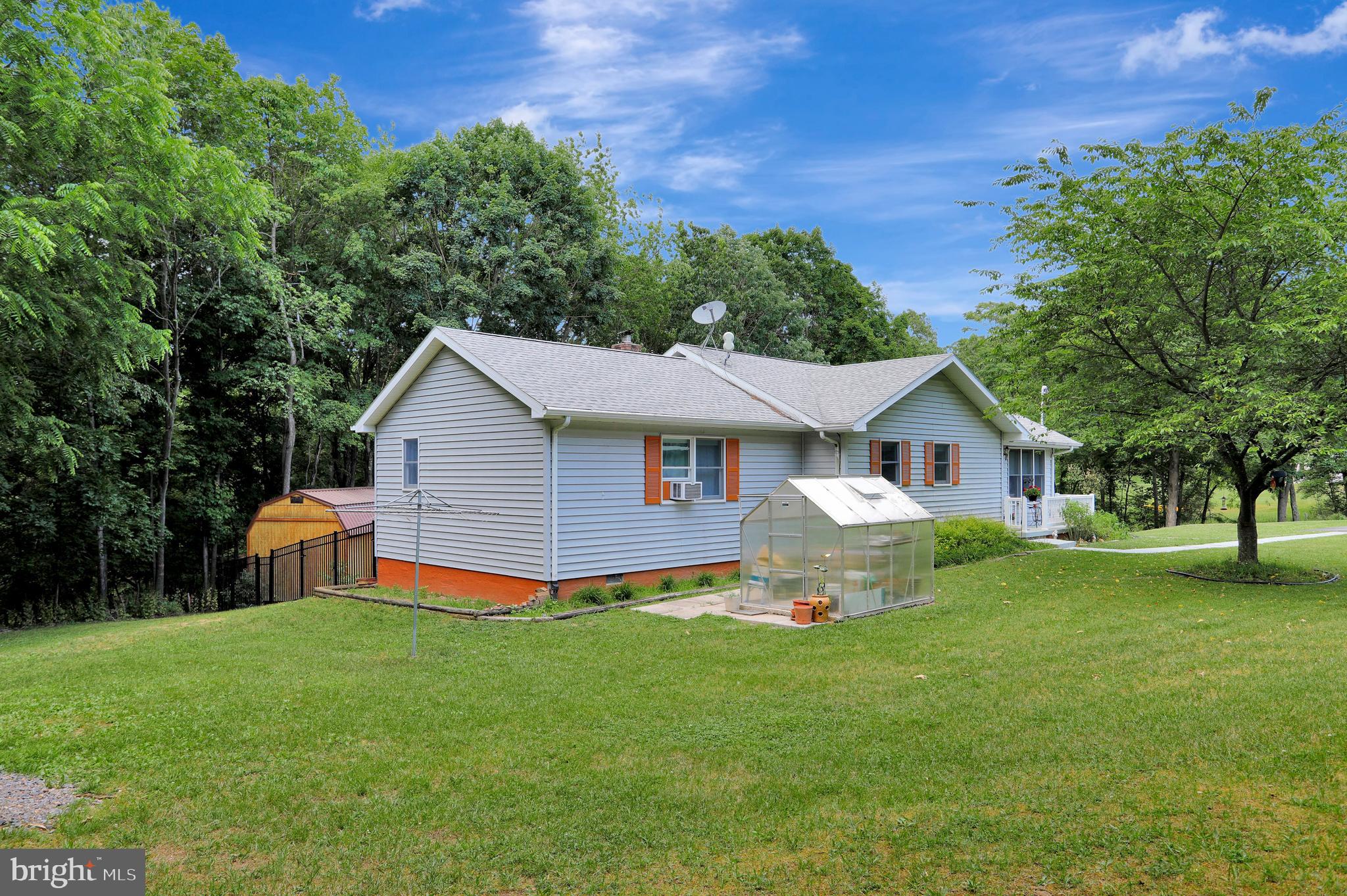 Charming 3 Bedroom 3 Bath Ranch home on just over an acre of land in quaint Berkeley Springs! This home features an Open Living Room, Dining Area located off the Kitchen, perfect for entertaining! Master Suite has a jetted soaking tub and full bath amenities. Two additional bedrooms share a full bath. Lower level has a finished Recreation room with Free standing wood stove, a Full bath, utility and laundry room, as well as the 1 car garage with a workshop area. Outside you will find a full workshop located off the patio and deck area as well an adorable finished building perfect to call your She-Shed or Man Cave!! An additional storage building is located off to the side yard. This home is perfectly situated close to hospitals and all that downtown Berkeley Springs has to offer such as shopping, dining, and entertainment! Schedule your tour today!