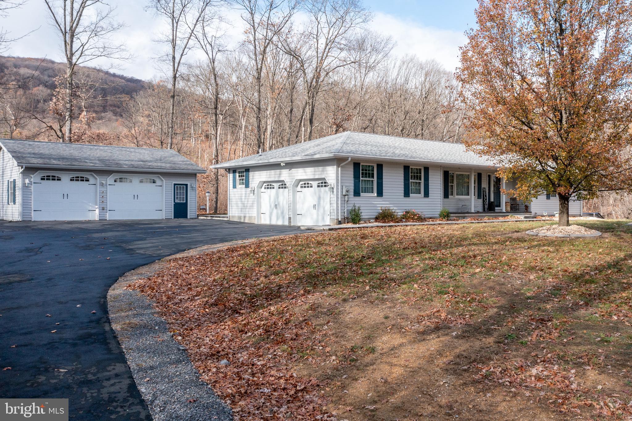 WEST VIRGINIA RANCHER ON 3.6+/- ACRES! Welcome to 154 Turnaround Drive! Turnaround Drive is a private lane that ends at this secluded, custom-built home! This property was built in 1995 and has been lovingly cared for ever since. The main level features a living room, a renovated eat-in kitchen with quartz countertops, stainless appliances, oak cabinets and built-in hutches, two spacious bedrooms, a full bathroom, sunroom and a large second bathroom/laundry room (with built-in storage and granite counters!). The basement is finished with a rec room (pellet stove conveys!), an office, half bathroom and large utility/storage room. There is plenty of parking with the 2-car attached garage AND the 2-car detached garage. Outside, the home has a cleared yard but is surrounded by trees and is very private! There are two outdoor patios and a storage shed. HVAC was replaced in 2021 and the roof is approx. 7 years old. NO HOA! Please no drive-bys. Call your agent for an appointment.