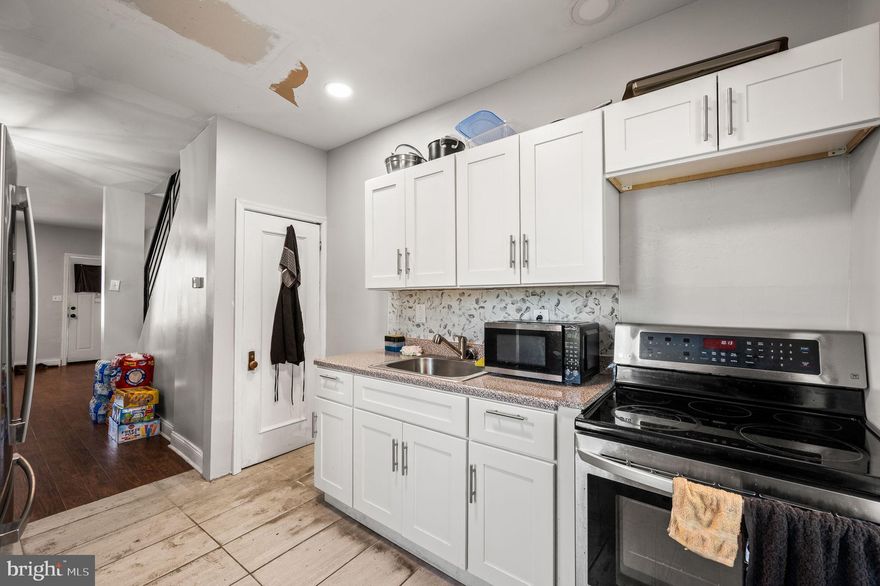 Welcome to 5036 Ogden Street—an updated 3-bedroom, 2-bath SouthWest Philly home that blends modern touches with classic character. This end-of-row property features central air, updated flooring, and a spacious living area that flows right into a bright kitchen with white shaker cabinets, stainless steel appliances, and a fresh backsplash. Upstairs you’ll find three well-sized bedrooms and a fully tiled bathroom with a contemporary design. Downstairs? A finished basement with a second full bath—perfect for guests, a home office setup, or that extra space you’ve been needing. The front porch is great for relaxing, and the large side yard adds rare bonus outdoor space—ideal for gardening, hosting, or expanding. Newer mechanicals and fresh paint throughout make this one move-in ready. Whether you’re a first-time buyer, investor, or someone looking to own in an appreciating area, 5036 Ogden checks a lot of boxes. Come see it today before it’s gone!