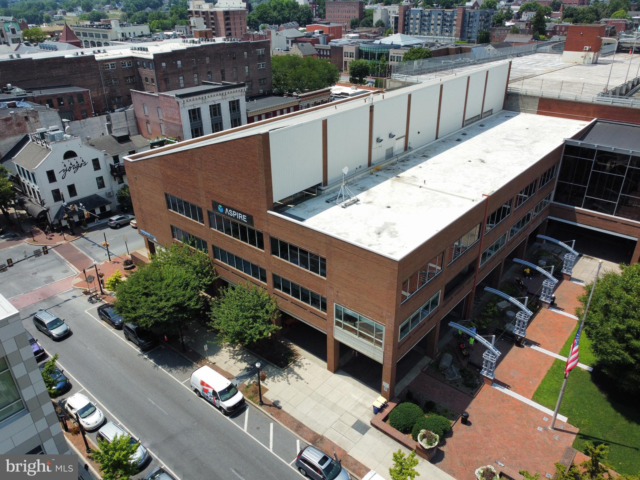 ***CALL FOR OFFERS: All offers will be presented!*** An opportunity to own a property like this in such a grand location only comes along once in a lifetime. This prominent building is situated one block north of Penn Square at the intersection of routes 222 & 462 (North Queen and Orange Streets), alongside Lancaster City's Binn's Park. Offering expansive windows on 3 sides of the building, direct interior connections to the Prince Street parking garage, 2 elevators, an indoor/outdoor area on the 2nd floor, class A finishes and a variety of amenities including a kitchen with hood system, auditorium, retail space currently used as an art gallery, fob security system, CAT 6 wiring, garage area in lower level, and more. Enjoy incredible signage opportunities with visibility to over 20,000VPD. Property includes the covered outdoor space making this an ideal site for additional retail, restaurant or new development opportunity. Well suited for owner occupant or investor/developer. Inquire for details. Sq. Ft. of approx. 77,294 is Gross Sq. Ft. including the lower level which is finished space plus the garage. Sq. Ft. above grade totals approx. 62,325 Sq. Ft. Enjoy tax, loan and grant incentives from the CRIZ. Floor plans available.