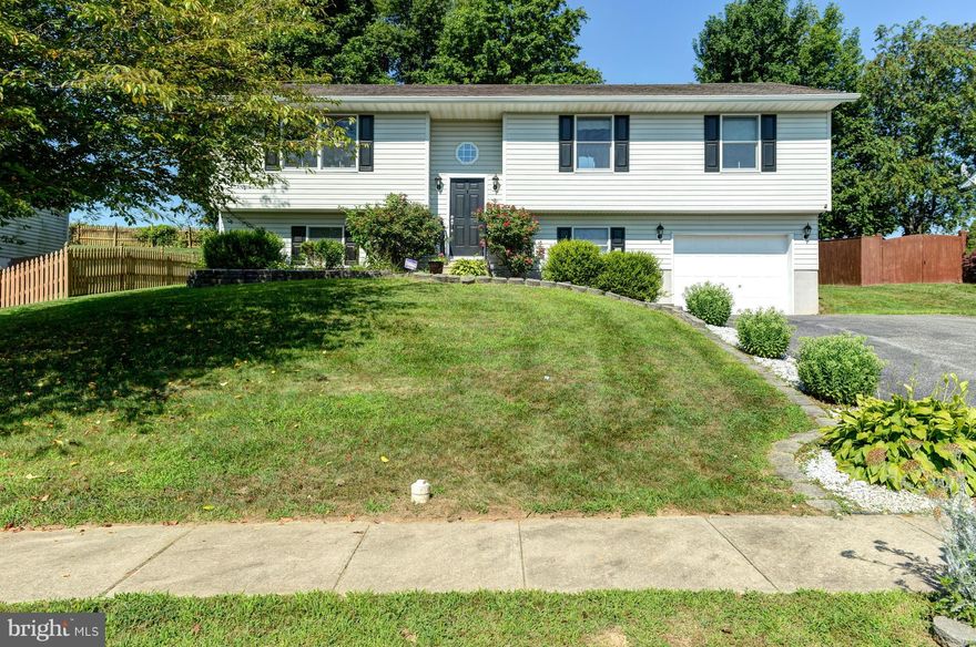 Spacious home in Rising Sun with 4 bedrooms and 2 full baths.  Features include a large country kitchen with sliders to the deck, a large patio, large lower level family room with pellet stove and a one car garage.  Beautiful back yard backing to farm land.