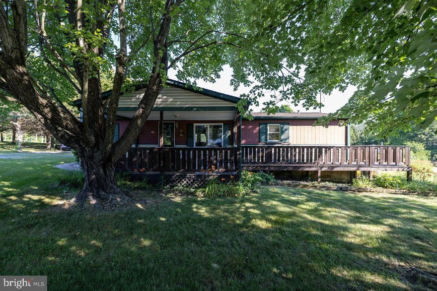 Handsome Manufactured Home! This 3 BR 2 BA home is in a desirable price range! Situated on two beautiful, level  lots totaling approx. 1.2 Ac. This home has an open floor plan creating a large living/dining area. Primary bedroom has private bath! Lovely large covered front porch with shade trees in the front yard! 
Why rent when you can own?!