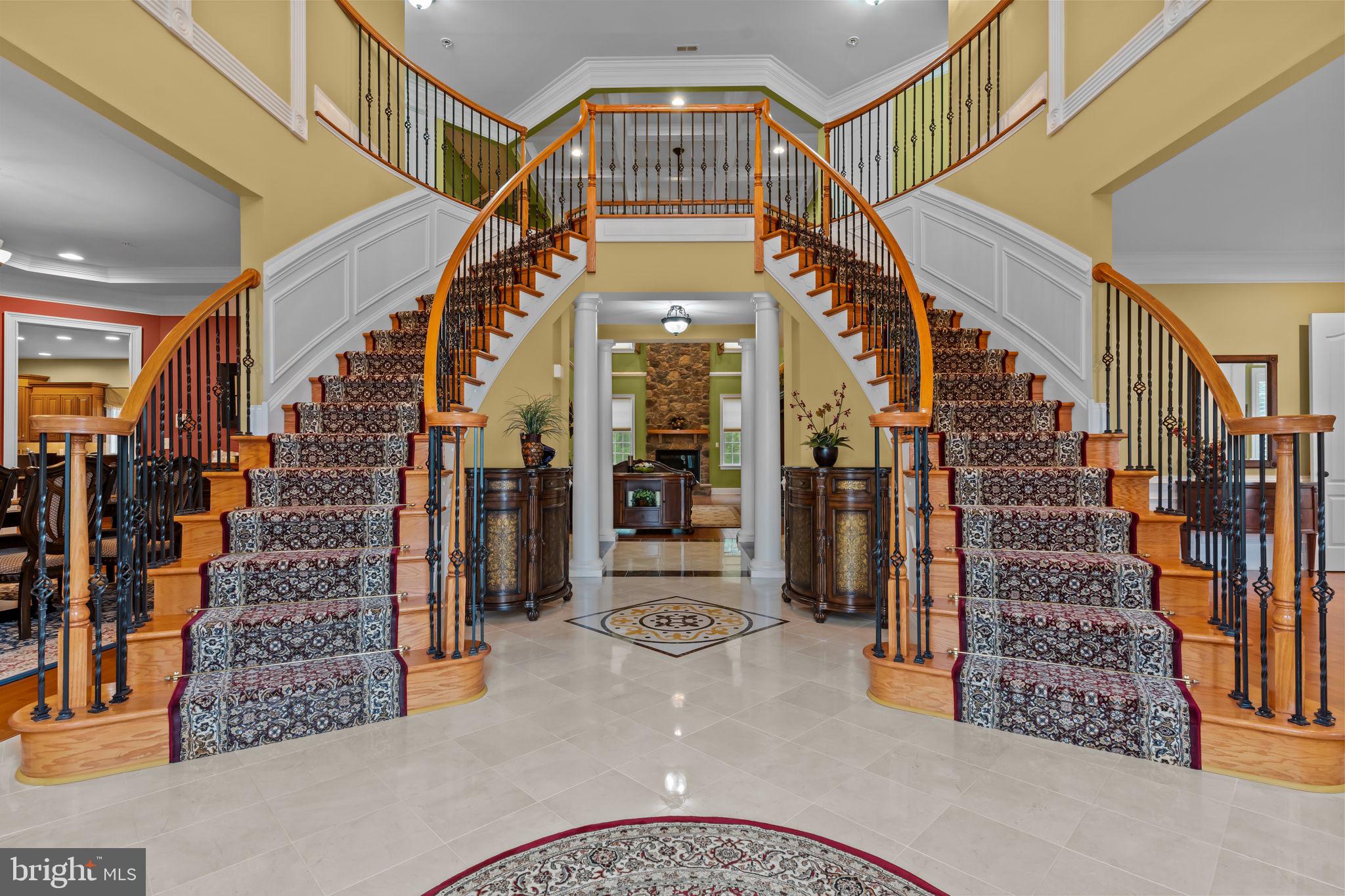 Welcome to this exceptional 5-bedroom, 4.5-bath estate, offering 6,584 square feet of luxurious living space, located on a quiet cul-de-sac in the coveted Chapman’s Corner community. Built in 2013 by Toll Brothers, this Henley Versailles model home features over $400,000 in premium upgrades, exquisite architectural details, and high-end finishes throughout.
A dramatic two-story foyer with dual curved staircases sets the tone for elegance and grandeur. Soaring 10-foot ceilings on the main level and 9-foot ceilings upstairs create an open, airy feel, complemented by oversized windows and custom millwork. Beautiful custom hardwood and tile flooring though out, including ceramic medallion in center of the foyer. The spacious two-story great room includes a striking 2 story stone fireplace, stunning “Coffered” ceiling, and flows beautifully into the heart of the home: a chef’s kitchen featuring rich wood cabinetry, granite countertops, a large center island, reverse osmosis water filter, subzero and professional-grade stainless steel appliances, walk-in pantry closet. The rear of the home was expanded during construction, to be even more spacious!
Retreat to the luxurious primary suite offering a bonus sitting room/office , 3 walk-in closets, dual toilets, dual vanities, an ultra shower, and a whirlpool soaking tub. Off the primary bedroom is another huge bonus room. The four additional bedrooms include an en-suite and a Jack & Jill layouts, offering privacy and comfort for family or guests. A fifth bedroom or optional office/playroom provides flexible living space that features extra storage closet with built in cabinetry.
Designed for both work and play, the main level includes a dedicated office with custom built-in shelving, a gym/playroom, and a bright, window-lined conservatory. The custom 4-car garage features built-in shelving, cabinets for storage, and a specialized floor system - perfect for the car enthusiast or extra storage. A full basement provides endless possibilities, with high ceilings, rough-in plumbing for full bathroom, enabling future expansion. Walkout stairs provide added light and convenience.
Additional highlights include a whole-house generator, expansive private backyard, custom designed front hardscape walkway with special features including large decorative water fountain, artistic post lighting and additional accent lighting. This home features full home security system with exterior cameras, and fire sprinkler system. This is an award-winning location in the Council Rock School District with an easy commute to Philadelphia, truly offering the perfect balance of luxury, space, and convenience. The lot boasts one of the best locations in “Chapman’s Corner,” a quiet cul de sac with expansive Bucks County views.
