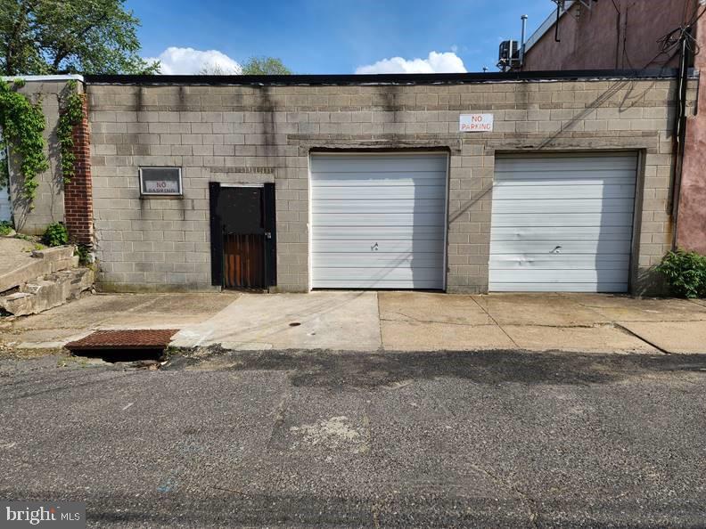 2520 SF heated former commercial garage workshop for plumbing and heating contractor with full bathroom, built out to property limits of 2663 SF. Located on a dead-end street at the base of legendary Helen Hill with other garages, residential housing, and a church. Built in 1971, frontage is 37’ 6” across addresses 3625, 3627, and 3629 Helen Street. Property stretches back 71’ 0”. Walls and roof supported by cinder block. Poured concrete floor with front center floor drain and no defects. Open floor space with extensive shelving and cabinets around perimeter. Parking for 8 or more heavy vehicles inside. Two overhead garage doors, one at-grade pedestrian door, one bathroom window all facing front. Steel garage doors are 9’ high by 8’ 10” wide with locks. Middle garage door has LiftMaster electric lift mechanism re-programmed with two Security+ remote controls with new batteries. Pedestrian solid wood door measures 6’ 8” high by 3’ wide with keyed knob lock and keyed deadbolt and a padlock on exterior steel bar door. Roof is supported by three oversized steel I-beams and slopes rear to front with roof drain located center front. Clearance to first (lowest) I-beam is 9’ 11” from floor. Rear 1/4 of ceiling wired for exhaust fan. Bathroom is 102 SF 17’ long by 6’ wide by 8’ high with toilet, vanity, stall shower, and changing area. Separately vented 30-gallon natural gas hot water heater located over bathroom with drain pan piped to laundry tub. Full size laundry tub located outside bathroom with nearby hose connection. 5” main sewer drain size. 1” water service. First 4 ft of water inlet pipes and meter are insulated to protect from freezing. Two overhead natural gas space heaters: primary forced air Modine unit heats entire garage; secondary infrared Modine unit rated 60,000 BTU heats work area in back corner. Nearest fire hydrant is directly across the street from the center overhead door. 240-Volt 100-Amp electric service with circuit breakers. Electric, water, and gas utility meters all located inside and read remotely.
This property has a solid infrastructure but needs cosmetic fixes inside caused by prior roof leaks. Owner has spent past 12 years organizing and selling contents and repairing and upgrading infrastructure including:
Replaced pitch and pebble roof with 15-year warranty rubber membrane over 2” thick insulating panels December 2018, installed roof crickets and new front wall flashing with 10-year warranty February 2024.
Installed custom steel bars inside over window and outside steel bar door over pedestrian wood door July 2016. Replaced 5” curb trap, water & sewer boxes, and new sidewalk block October 2018.
Serviced electric door lift mechanism November 2018, replaced central garage door September 2024.
Installed quarter turn main water shutoff before meter December 2019, new 20-year water meter April 2024.
PGW replaced service main March 2025, new meter on April 2025. Primary space heater fan & motor replaced January 2015.
Replaced storm windows & screens with new screen and plexiglass panels September 2022.
Repaired laundry tub drain and replaced faucet July 2017. Began replacing overhead bulbs with LED December 2023.
Prior roof leaks at wall next to bathroom damaged bathroom framing needing rework. Bathroom toilet and stall shower are in good condition, but sink needs new vanity frame yet plumbing continues to operate.
Possibility of adding residential space above existing garage space, already done at other properties on the same block.
Property is being sold in its present "as-is" condition & is loaded with plumbing, heating and electrical parts and tools from prior owner's estate. No warranties expressed or implied. Buyer will be responsible to clear out the property except for the items Seller is taking.