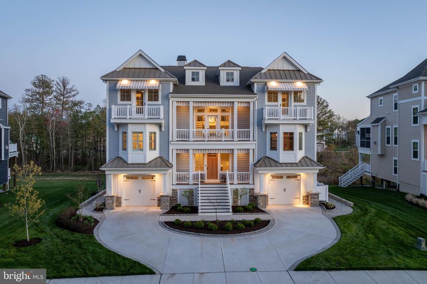 HIGH-END CUSTOMIZATION MEETS COASTAL PERFECTION in this Marsh Island Estates masterpiece that far transcends standard builder grade. Wrapped in premium Hardi-Plank fiber cement siding for ultimate durability, this 5-bedroom, 5.5-bathroom estate redefines luxury across three levels of meticulous upgrades. The exterior sets a grand tone with a circular paver-bordered driveway, Belgium block curbing, and high-performance Andersen windows featuring warm wood interiors and weather-resistant vinyl exteriors. Inside, the home makes a lasting impression with soaring 8-foot solid core interior doors and a two-story coffered ceiling Great Room anchored by a floor-to-ceiling stone natural gas fireplace and premium engineered wood flooring.

The culinary space is a designer’s dream, boasting quartz countertops, a breakfast bar, and a sophisticated custom pantry scullery. No expense has been spared in the bespoke interior, from the custom Ralph Lauren fabric window seat in the library to the designer wallpaper and mirrors in the powder room. The main-level primary suite serves as a true sanctuary with custom closet systems and a spa-inspired marble tiled bath, while the top floor hosts three additional bedrooms, each with en-suite baths and walk-in closets. High-tech enhancements abound, including a comprehensive security system, surround sound, Hunter Douglas treatments, and tinted rear windows for solar protection.

Outdoor living is truly unrivaled, featuring a rear paver patio with a built-in fire pit and an expansive screened porch enclosed with an EZE Breeze window system for year-round enjoyment. Multi-level decks offer panoramic vistas of the surrounding wetlands and Love Creek, which leads directly to the Rehoboth Bay. Residents enjoy immediate water access via a community boardwalk and pier system. This is not just a home; it is a meticulously curated retreat where every detail, from the epoxy-finished garage floors to the architectural-grade finishes, provides a living experience far superior to any standard construction. Contact us today to experience this coastal crown jewel in person!