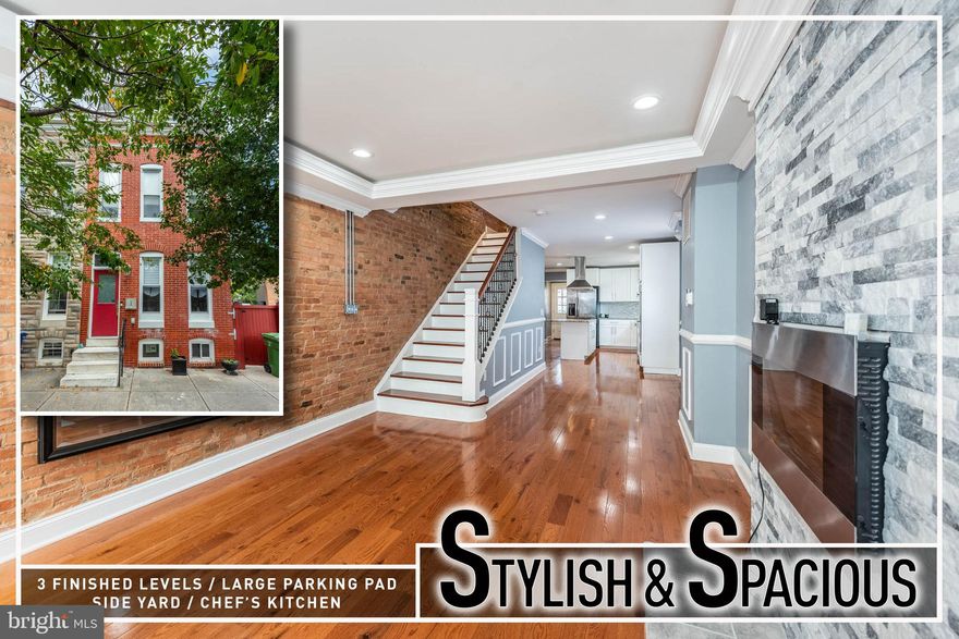 Stylish and spacious end-of-group rowhome boasting over 1,900 sq. ft. of beautifully designed living space. Step inside to find gleaming hardwood flooring throughout and an inviting open-concept main level. The light-filled living room is anchored by an electric fireplace with a dramatic stacked-stone surround, creating a warm focal point. The gourmet island kitchen is a showstopper, featuring sleek granite counters, stainless steel appliances, a cooktop with wall oven, a pantry for storage, and an oversized island that doubles as the perfect spot for casual dining or entertaining. A convenient half bath completes the main level.  The second level offers versatility with a private bedroom suite featuring a full bath, as well as a second bedroom served by a hall bath. Retreat to the third-level Primary suite, a true sanctuary with two walk-in closets and a luxurious bath with double sinks, a spacious vanity, and modern finishes. Enjoy direct access from the suite to the rear deck, which connects to the expansive rooftop deck—ideal for entertaining, relaxing, or simply soaking in sweeping city skyline views.  Additional highlights include an unfinished basement perfect for storage, a large fenced yard with plenty of room for gatherings, and rare off-street parking for multiple cars.  Situated in a convenient location close to Downtown Baltimore, stadiums, UMMC, and major roadways, this home combines modern design, thoughtful features, and unbeatable outdoor spaces—making it the perfect place to call home.