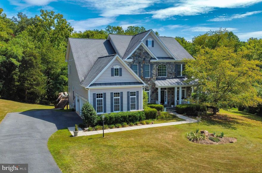 Custom stone front 4 bed/4.5 bath colonial, featuring almost 6000 square feet of living space and 3 car side load garage on almost 5 private acres in Waterford View Estates!  This stunning property boasts an open floor plan complete with 10 foot ceilings on the main level, a dramatic 2 story foyer, formal living and dining rooms, a vaulted side solarium with walls of windows and private composite deck, a main level study, a stunning gourmet kitchen w/ island, granite, custom cabinets and lighting, and a large family room complete with gas fireplace!  There's a 3 way staircase to the upper level that features a luxurious, oversized primary suite complete w/ sitting room, 2 walk in closets (one with a laundry chute), and an oversized primary bath w/ dual vanities and jacuzzi tub!  Their are 3 additional bedrooms, including a connecting full bath between 2 bedrooms, and a bedroom suite complete w/ it's own full bath!  The finished walk out lower level features lots of natural light and wide open finished space for entertaining, and includes a full bath, a gas fireplace, a second study/office, 2 storage areas, and a unique space under the porch for a future wine cellar! This home sit's on almost 5 private acres (both cleared and wooded) and features 2 composite decks overlooking your backyard oasis!   This lovely home is just 5 mins to downtown Lovettsville that features restaurants, coffee shops and more, a 15 min drive to the MARC train offering a 1 hour commute into DC, and is surrounded by the areas finest local wineries and breweries.