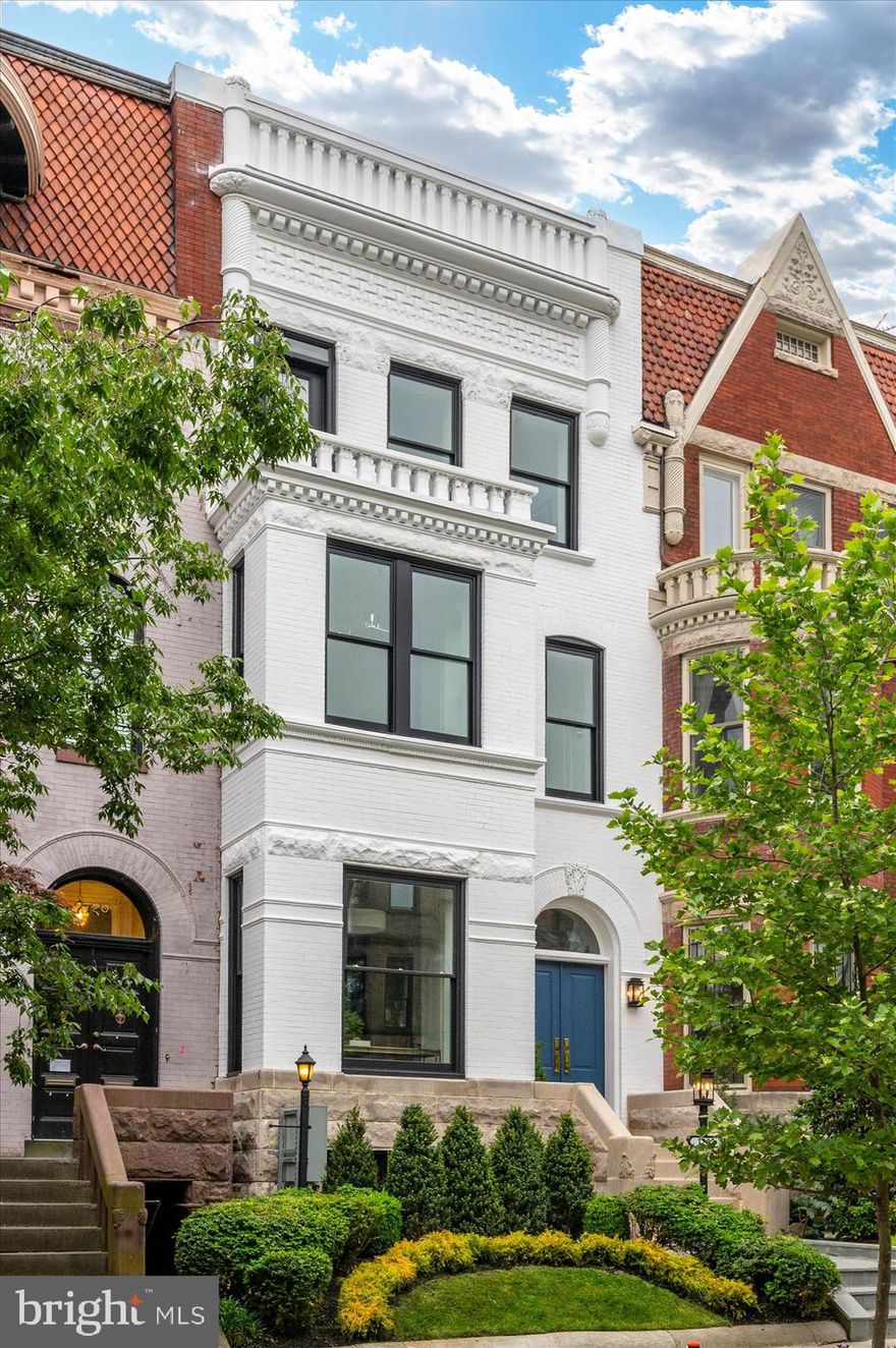 Indulge in the ultimate expression of opulence with this newly renovated rowhome by District495 Properties, where luxury living is redefined. Nestled along one of Dupont Circle's most enchanting tree-lined streets, this spectacular 6 Bedroom, 4.5 Bathroom home spans four floors and over 3,400 square feet, exuding charm that is unparalleled.


A true masterpiece, every detail has been meticulously crafted, from the custom front doors to the 10.5-foot ceilings in the elegant living and dining rooms, the floor-to-ceiling glass windows that welcome the natural light into the entire living space on the main floor, and the professionally landscaped front and back yards. As you walk through the enchanting interior space, the hand-picked marble selections, timeless White Oak hardwood floors, custom millwork, designer lighting, and top-of-the-line fixtures by Waterworks, create a sensational experience.

The open-concept kitchen with its custom cabinetry, ILVE Majestic stove, Thermador appliances and Shaw sink is an entertainer's delight, perfect for hosting large family gatherings and social events. The second level is dedicated exclusively to the primary suite, complete with a separate office, sitting area, and a dressing suite that is a work of art with its custom-built cabinetry. The primary bathroom is a luxurious haven, boasting Waterworks fixtures, dual vanity sinks, a large soaking tub with a fireplace above, and a shower that is perfect for two with its dual rainfall system. The upper-level features 3 additional bedrooms and 2 bathrooms, one of which is ensuite, offering ample space and privacy for family members or guests.


The lower level of this stunning property offers great flexibility with its full kitchen and separate entrances, serving as additional family gathering space or a potential one-bedroom rental opportunity, making it an excellent investment. The beautiful back patio provides an ideal setting for relaxation or outdoor entertainment. Enjoy the convenience of two full-size secure parking spaces each with its own EV charger, as well as the ability to park an additional car behind the roll-up door. The home is equipped with all the extras needed for entertaining guests, including 3 sets of washers and dryers and audio speakers throughout the house, leaving no detail overlooked and no expense spared.