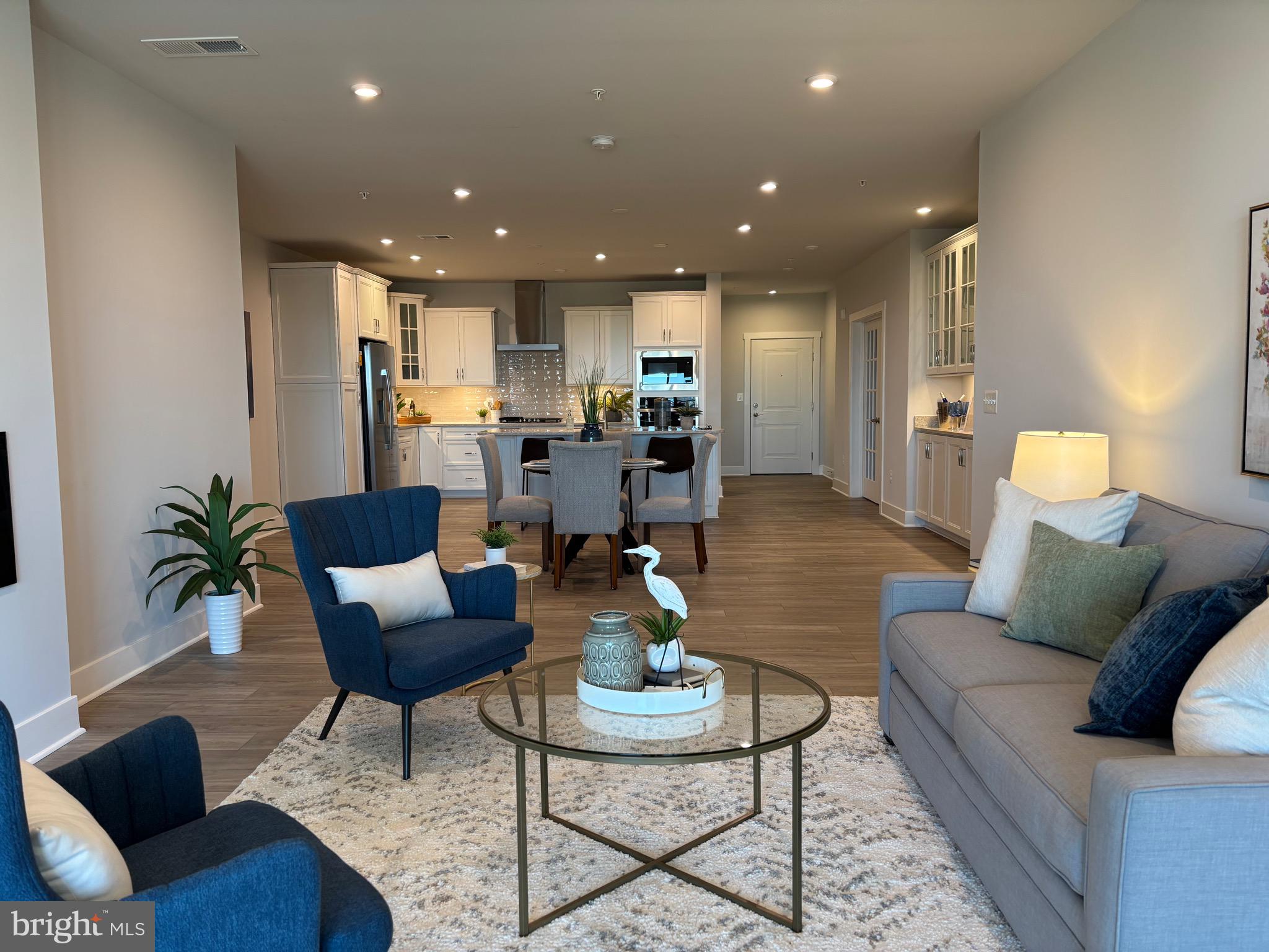This Chester model has scenic views of the river, beautiful sunrises, and an incredible display of wildlife in all seasons. Upgraded lighting package, dry bar, and fireplace are just a few of the features of this award winning condominium. With nearly 2000 square feet of open living space on one floor, this home has a great layout for entertaining friends and family. Spacious Great Room, dry bar cabinet, modern electric fireplace, and sliding glass door that opens to the balcony. The heart of this home is the gourmet kitchen. The main feature of this space is the oversized kitchen island with stunning quartz counter tops, and beautiful upgraded cabinetry. It is equipped with GE Profile appliances. The primary bedroom has a luxury owner's spa bath, a spacious walk-in closet and plenty of light. The bright and airy 2nd bedroom is a separate suite with a full bath and oversized walk-in closet. In addition to the two bedrooms, you have a home office with stylish French Doors. The separate laundry room is equipped with energy efficient, oversized washer and dryer. Off the foyer is a half bath for family and guests. This home also has a garage with adjoining driveway/parking space and large personal storage room which is a few short steps from the elevator. This unit is just a short walk to resident kayak racks with launch access to the Chester River. KEEP IN MIND THIS CHESTER MODEL IS MOVE-IN READY WITH PLENTY OF HIGH-END DESIGNER FEATURES AND UPGRADES ALREADY INCLUDED***** Brand New 24,000 Square Foot Clubhouse with Stunning Chester River Views! Fantastic amenities include 4.3 miles of walking trails throughout the community, outdoor infinity pool, indoor pool with on-duty lifeguard, fitness center, library,
game room, gas and wood burning fire pits, Tiki bar equipped with refrigerators, sinks and television monitors, pier with transient boat slips, walking paths that link to the Cross Island Trail, lighted pickle ball courts, tennis courts, bocce, dog park, and an outdoor amphitheater for live music and movie nights. The community lifestyle director will keep you busy with daily activities such as yoga, a variety of exercise classes and an assortment of clubs including biking, billiards, book club, baking, mahjong, environmental club, trivia night and more. In addition to the weekly and monthly activities, residents can enjoy crab feasts, oyster roasts, and holiday gatherings throughout the year. This development is an unrivaled, amenity-filled, resort-style experience with convenient access to Annapolis, DC, Baltimore, and BWI. Kent Island offers multiple dining and shopping options, a nearby outlet mall, and a 6.5 mile cross-island trail surrounded by views of the Chester River.