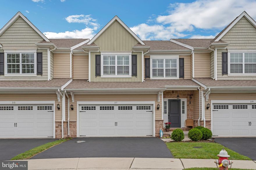 Welcome to 37 Addison Lane!  Looks can be deceiving...so be prepared to be wowed by this impeccably maintained and spacious carriage home.  With nearly 2,700 square feet of finished living space on the upper levels, this home offers the comfort of single-family living with the ease of a low-maintenance lifestyle.  From the moment you step inside, you will be impressed by the upgraded finishes and elegant details.  The main level features a cozy reading area adjacent to the formal dining room.  Continuing further back, you are greeted by an open concept layout where the family room, breakfast nook and kitchen are together as one space.  The area is perfect for both daily living and entertaining.  The well-appointed kitchen features ample cabinetry, granite countertops, and stainless steel appliances.  The breakfast area has a large sliding door that leads onto a composite deck, perfect for a table/chairs set and an area to grill.  The view from here is beautiful with the trees and greenery!  Imagine sitting at the table in the morning, sipping your coffee...or in the evening with a glass of wine!  Beautiful hand-scraped hardwood floors are featured through the entire main floor, up the stairs and into the loft area adding to the warmth of the space.  Upstairs, the generously sized primary suite features great windows to bring in natural light.  The en-suite bath has a free-standing soaking tub, double sinks and an oversized shower stall.  The upstairs laundry room is huge!  It is a true room with storage, a closet and plenty of room to sort and fold.  Two additional bedrooms with ample closet sizes for storage and a hall bath complete this upper level.  But don't miss the finished basement, which adds 500 square feet of finished living space.  This area can be used for a rec room, tv room, exercise space, home office space...the possibilities are endless!  The sliding glass door leads you outside to a covered patio, perfect for sitting and enjoying the outdoor space.  And the unfinished storage area is large enough for all your seasonal needs.  37 Addison is located in Collegeville Boro, on a quiet cul-de-sac.  It is the perfect location being close to restaurants and shopping, a short drive to Rt. 422 for commuting, and the Perkiomen Trail for walking and bicycling.