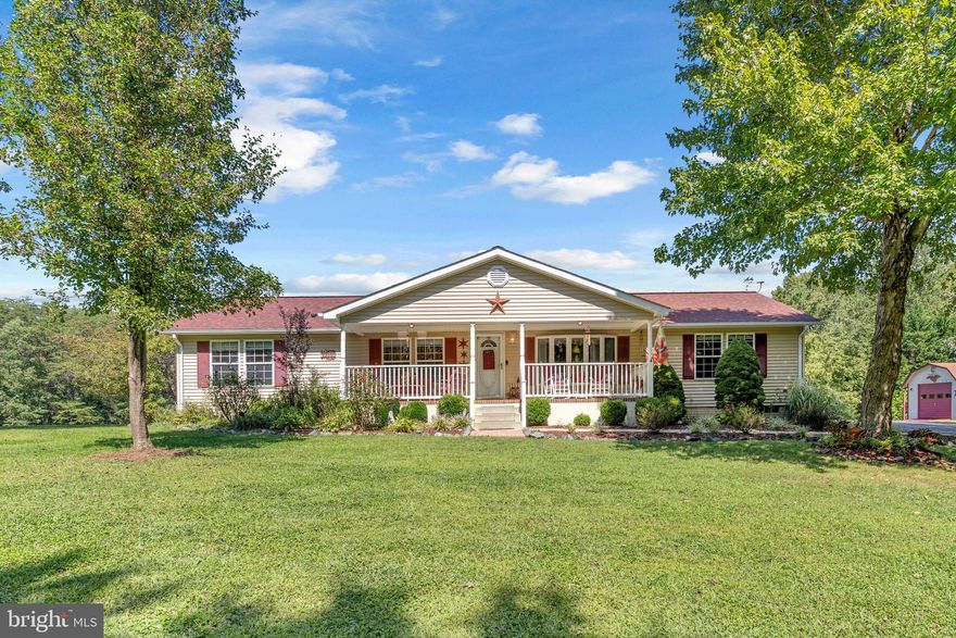 Looking for privacy, then look no further! This quaint ranch home sits on the most BEAUTIFUL piece of property where you can enjoy 3.3 acres of serenity.  Sip your coffee on your cozy front porch or sit on your back deck overlooking a pond, and feel the nature all around you.  The landscaping is well manicured, and the grass is lush! Inside you will see that this home is a true COUNTRY CHARMER!  Enjoy one level living with 3 bedrooms, 2 full baths & almost 1800 sq ft.  It has a flexible floor plan, with a living room, family room, and separate dining room.  Cook up a great meal in the large kithchen with granite counters and lots of prep space.   The family room is the heart of the home with a cozy woodburning fireplace & overlookng the back deck.  The Primary Suite has a vaulted ceiling, a large bathroom with a soaker tub/shower combo, and a large walk in closet.  You will find gleaming hardwood floors throughout some of the home, newer carpet & tile.  The roof is only 5-6 years old, updates to HVAC, & well pump.  LOTS of parking available in your DETACHED garage that could fit 2 cars, a detached carport for another 2 cars, and a wide driveway.  You will not want to miss rare find! Click on movie camera icon to see aerial tour.