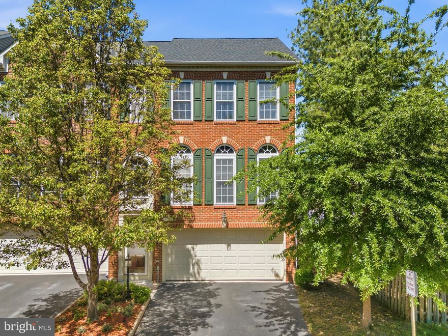 Beautifully maintained, light-filled end-unit townhouse located in the sought-after Lorton Station South community, just a short walk to Lorton Town Center, offering convenient access to shops, restaurants, and the VRE commuter rail.

This spacious three-level home features hardwood flooring throughout, with a well-appointed kitchen offering luxury vinyl plank flooring, upgraded maple cabinetry, wall oven & fridge stainless steel appliances, corian countertops, and a bright eat-in area. Step out to a large Trex-style deck overlooking open green space—ideal for both everyday living and entertaining.

A full three-level bump-out provides expanded living space, making this one of the larger models in the neighborhood. The fully finished lower level includes a recreation room with fireplace, full bathroom, and walk-out access to a fully fenced backyard—well-suited for guests, extended family, or flexible use.

The upper level features a generously sized primary suite with dual vanities, a soaking tub, and separate walk-in shower, along with two additional well-proportioned bedrooms and a shared hall bathroom.

Recent updates include roof (2024), water heater (2024), HVAC (2019), and insulated garage door with opener (2021). Ring security system conveys.

Residents of Lorton Station South enjoy access to community amenities including a swimming pool, playgrounds, and walking paths. Just moments away, Lorton Town Center offers a walkable mix of dining options, coffee shops, fitness studios, retail, and everyday conveniences, along with the VRE station providing direct access to Washington, D.C. Easy access to I-95 further enhances commuting options.

Located within a highly regarded school pyramid including Laurel Hill Elementary School, South County Middle School, and South County High School.