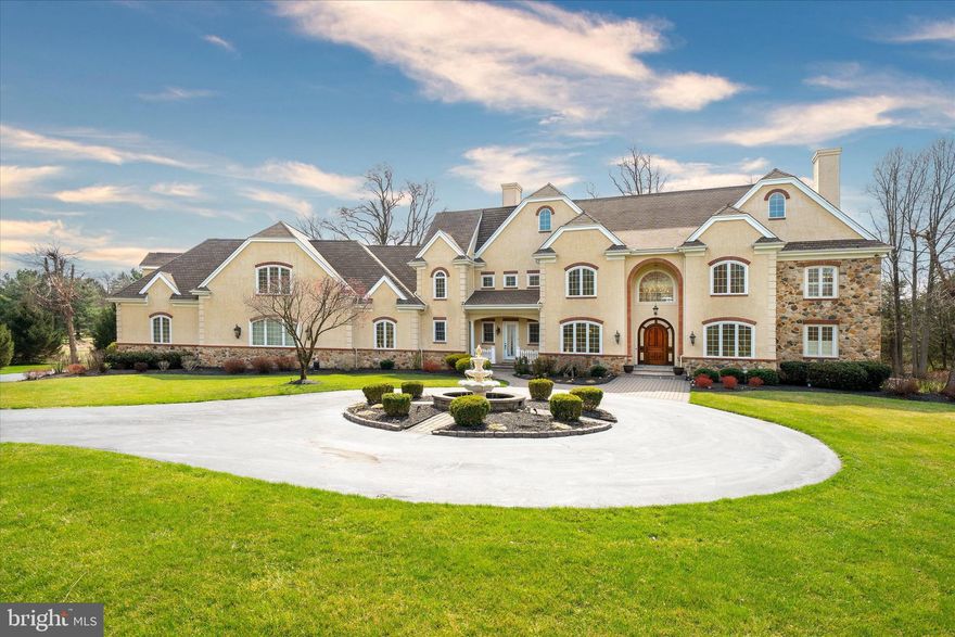 Welcome to this truly exceptional custom-built estate, privately set on 2.34 acres in the prestigious Chateau Country of Centerville, Delaware. Tucked behind an automatic double driveway gate, this extraordinary residence offers a rare blend of privacy, luxury, and thoughtful design. An architectural masterpiece, the home showcases an unparalleled level of sophistication and functionality, enhanced by exquisite finishes and a prime private setting. Professionally designed landscaping, a manicured lawn, mature ornamental trees, and a grand four-tier fountain create a striking and elegant arrival experience.

As you enter, an impressive foyer with marble flooring sets the tone for the elegance found throughout. The main level is thoughtfully designed, featuring a formal sitting room and an elegant dining room with a butler’s pantry. One of the home’s most impressive architectural focal points is the breathtaking two-story grand living room, highlighted by dual overlook balconies, custom millwork, architectural columns, and a striking chandelier centerpiece, creating an unforgettable setting for everyday living and entertaining.

At the heart of the home is the gourmet kitchen, beautifully appointed with a large center island, top-of-the-line appliances, granite countertops, and abundant cabinetry. The adjoining breakfast area features sliding glass doors leading to the side hardscaped patio, creating a seamless connection for outdoor dining and entertaining. The kitchen flows effortlessly into the stunning two-story family room with a coffered ceiling, floor-to-ceiling windows, and a fireplace centerpiece. Just beyond, the vaulted sunroom is filled with natural light and provides a peaceful retreat.

The main-level primary suite is a luxurious private retreat, complete with a vaulted sitting room and two-sided gas fireplace. The spacious primary bathroom features an oversized shower, spa tub, dual sinks, a dedicated vanity area, and two walk-in closets.

From the kitchen, a hallway leads to a private wing featuring elevator access, a full bathroom, a laundry room, and two home offices, ideal for remote work or flexible living space. From the rear rooms of the main level, step outside to the expansive 3,000-square-foot wraparound patio overlooking unoccupied land, complete with an outdoor kitchen. The lush lawn and private meadow views create a serene outdoor setting.

Upstairs, you will find four additional bedrooms, including two en-suite, a Jack and Jill bath, and a private wing ideal for an in-law, au pair, or guest suite. With elevator access, this space includes a sitting area, a room prepped for a future service area or kitchenette, a full bathroom, a spacious living room, a private bedroom, and an additional laundry area.

The lower level presents exceptional entertaining space with a wide-open layout, featuring a granite bar, private home theater with tiered seating, fitness studio, and full bathroom. French doors and stairs lead directly to the exterior terrace, offering seamless indoor-outdoor flow and the potential for a future pool.

Additional highlights include elevator access to all three levels, a generator, and a four-car rear-entry garage with epoxy flooring and Tesla charging.

Perfectly situated across from Greenville Country Club in the highly sought-after Centerville area, this exceptional estate enjoys a premier location near golf, swimming, dining, and racquet sports, with convenient access to many of the area’s most exclusive golf courses and country clubs. Residents will appreciate close proximity to scenic park trails, Winterthur, Longwood Gardens, and an outstanding collection of fine dining and shopping, while Philadelphia International Airport and Center City Philadelphia are approximately 30 minutes away. Combining timeless architecture, exceptional craftsmanship, and a private setting of rare distinction, this is a remarkable offering in one of Delaware’s most coveted locations.