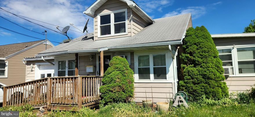 Cape Cod House for sale with fenced in backyard and a one car garage.