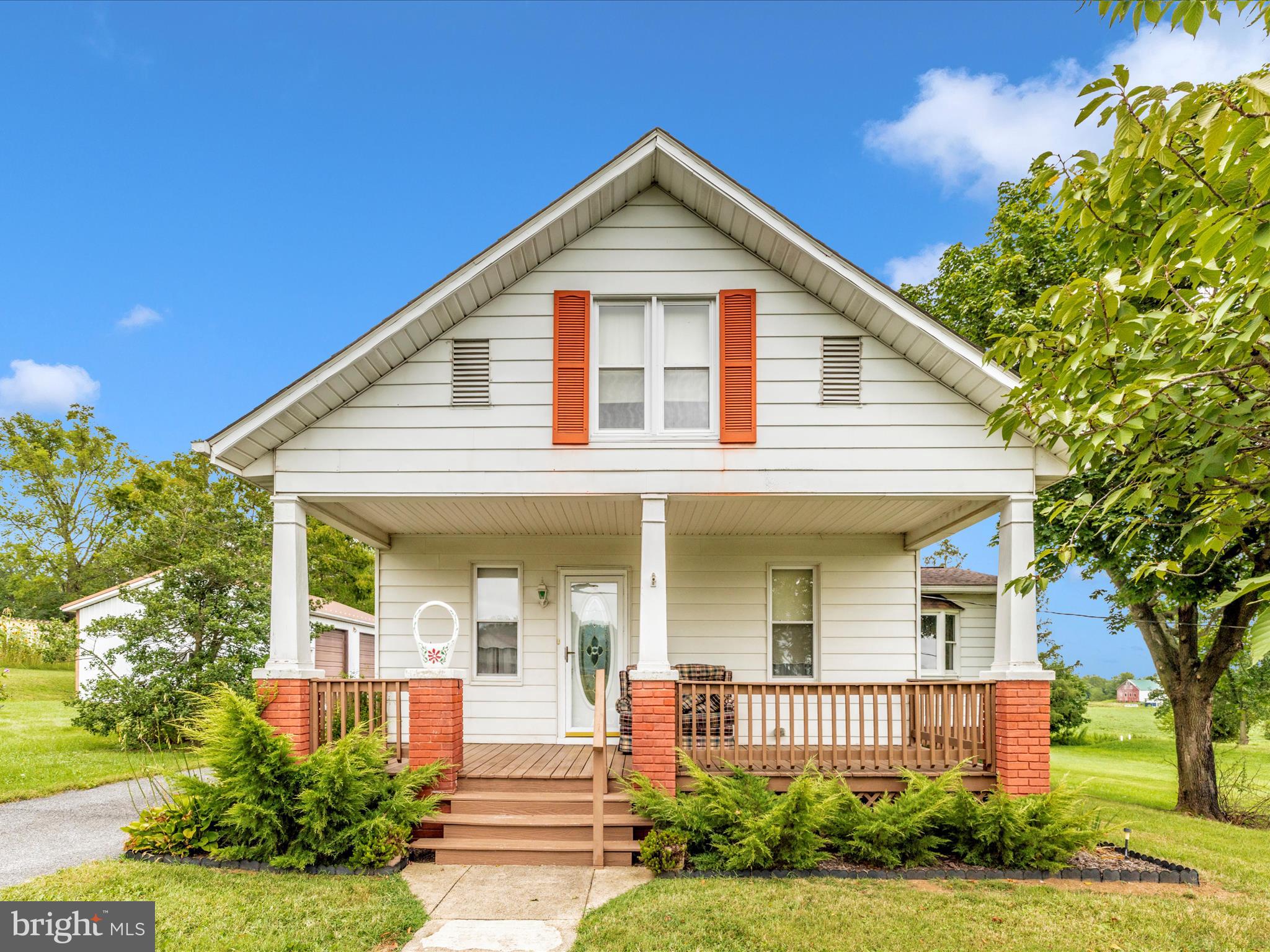 Tucked in the heart of Rocky Ridge with pretty views all around, this charming Cape Cod-style home offers that vintage feel with all the important updates already taken care of. A large addition provides plenty of flexible space while keeping all the character intact. The main level features a primary bedroom, two full baths, living room and dining room with wood floors, and an updated kitchen with solid-surface countertops, tons of cabinet space and a sunny breakfast area. One of the highlights is the huge family room on the main level, perfect for gatherings or relaxing. The second full bath on the main level includes a walk-in shower. Upstairs you'll find two additional bedrooms, and the basement provides a laundry area and plenty of storage. Recent updates include a roof done approximately 10 years ago and replacement windows, blending that vintage charm with peace of mind. The exterior is a dream for anyone who needs space for vehicles, woodworking, or hobbies – a massive detached garage with oversized garage doors makes an ideal workshop, plus an additional garage with sliding barn-style doors and several more sheds for storage. The lot is lovely and offers a coy pond and pretty views. A special property, hard to find and easy to fall in love with!