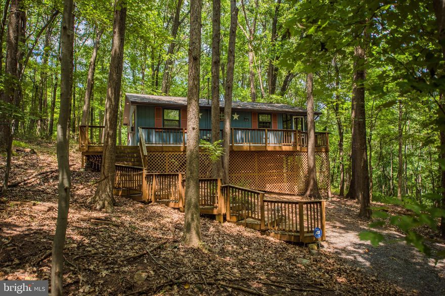 You ll enjoy playing on the lake!  Sleepy Hollow community includes a private beach, 7 acre lake for swimming and fishing. Check out the baseball field. Close by is Sleepy Creek Wildlife Management area excellent for hiking. This Well-maintained, private cabin on a 3.13 wooded acre lot in a cul-de-sac, offers peace and serenity. Enjoy the wildlife and the surroundings from the screened in porch or the wrap around deck. 2 bedrooms, and 1 full bathroom with washer and dryer, oak flooring in kitchen and hallway, living room with propane heating.  A must see when looking for that get-away cabin.