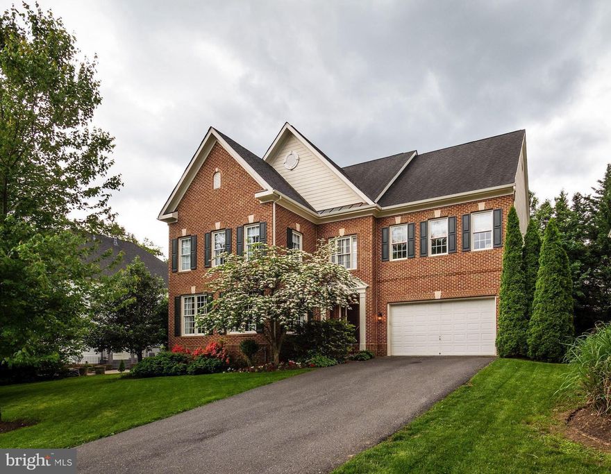 Welcome to 5402 Spruce Tree Ave. This 2002 custom built property by M/I Homes is located in Spruce Tree Village and offers over 5,000 square feet of finished space. The main level has beautiful dark oak hardwood flooring throughout, an open, sunny entry foyer and a large, open dining room that seats 12 comfortably. The formal living room measures 19'5" x 14' 0". A true cooks gourmet kitchen has a butlers pantry with wine refrigerator, double GE Profile electric ovens, a 6 Burner Jenn-Air gas downdraft stove top, a built-in microwave, solid full height wood cabinets and center island with cabinets below and granite countertops. The kitchen combines a breakfast room 14' x 12'8" with built-in desk and cabinetry above and door to rear patio. The adjacent great room is 19'0" x 18' 1" with a  gas fireplace and custom wall unit.   On the upper floor, double doors lead to a large master suite which has 2 spacious walk-in closets, his and her sinks with granite counter-tops, a large corner soaking tub and large walk in shower with double shower heads and glass enclosure. 3 additional bedrooms, one with private full bath and the other two share a jack and jill bathroom. There is an additional open loft sitting/office/study area overlook the first floor. Second floor laundry room for convenience. The lower level has a finished bonus room measuring 13'7" x 21'8" and full bath. Additionally there is a large fully finished recreation room that measures 28'7" x 15'4" There is an unfinished storage room 18'5" x 17'4". Stairs lead from recreation room to fenced in back yard and paver patio.  Additional features include custom moldings and trim as well as custom plantation shutters on the main level. Convenient location, excellent schools and a quiet street make this home a must see!