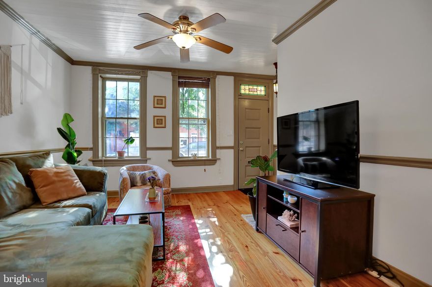 An architecturally significant historic and charming townhouse centrally located in the heart of the Original Fells Point Historic District .  This highly desirable Federal era townhouse features  heart pine wood flooring throughout except in the kitchen where the unique flooring is constructed of brick. This kitchen may have been added 100 or so years ago and serves to increases the footprint of the house.  It does not appear that the Baltimore City records reflect it's existence.  Another of its unusual aspects is its tin ceiling.  The extra space provided by the add on kitchen offers a good bit  more room for the entertaining  area which is additionally enhanced with a ground floor level powder room.  The wrap around yard  is on the  smaller side albeit large enough to provide room for the grill and  running room for the pets.  There are 2 bedrooms located on the second floor while the third floor has 2 more loft style bedrooms but because they are not private we consider them only as 1 . Parking for this area is by city permit, however,  located within less than 2 blocks, public monthly parking can be found in 2 garages as well as 2 parking lots.   A good coat of gray interior paint could go a long way into bringing this house in line with contemporary tastes. Please note the Matterport reads 808 S. Bond. The correct address is 805. Enjoy the self directed tour.