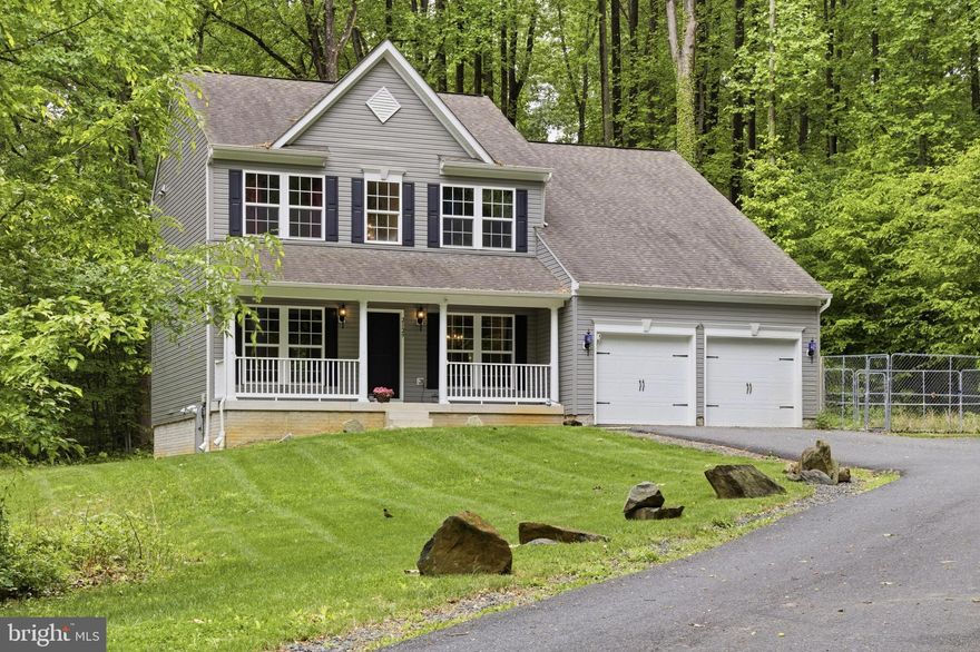 Tucked away on 2.85 private wooded acres, this beautiful home offers the perfect balance of peaceful living, modern comfort, and space to truly enjoy both inside and out. From the moment you pull into the driveway, you are surrounded by nature, privacy, and a setting that feels like your own retreat while still being conveniently located. The charming covered front porch welcomes you home and sets the tone for everything this property has to offer.
Inside, you are greeted by an open and spacious layout filled with natural light, crown molding, recessed LED lighting, and durable pet proof laminate flooring throughout the main level. The heart of the home is the stunning floor to ceiling custom stone propane fireplace with remote control and built in stereo system servicing both the first and second floors, creating a warm and inviting atmosphere for everyday living or entertaining guests. The kitchen offers granite countertops, soft close cabinetry, stainless steel appliances, oversized pantry, island seating, garbage disposal, and a RainSoft filtration system installed at the kitchen sink. The formal dining room flows beautifully into the rest of the home and offers plenty of space for gatherings and special occasions.
One of the most unique features of this property is the thoughtfully designed smart pet access system leading from the mudroom through the garage to a fully fenced 20x20 concrete dog kennel area, making this an ideal setup for pet lovers while also offering future possibilities for a detached garage, workshop, or additional outbuilding. The expanded asphalt driveway provides parking for approximately 7 to 9 vehicles along with a convenient trailer turnaround area.
Upstairs, all four bedrooms are generously sized with ceiling fans and ample closet space. The spacious primary suite feels like a private escape with two large walk in closets and a luxurious en suite bath featuring double vanities, a stand up shower with built in bench, and an impressive 75 gallon soaking tub designed for relaxation at the end of the day.
The lower level offers approximately 600 square feet of finished living space with a welled emergency exit, additional unfinished storage space, rough in plumbing for a future full bath, laundry area, and endless possibilities for a future 5th bedroom, recreation room, gym, office, or extended living space.
Additional features include a whole house RainSoft water filtration system, HVAC UV filtration system, whole house sprinkler system, well and septic, 500 gallon leased propane tank, gutters with guards, color changing LED front porch lighting, conduit installed for future driveway lighting, property line fencing, and access to ATV trails for outdoor enthusiasts. Recent updates include new basement carpet in 2024, asphalt milling parking pad in 2024, expanded 5 car asphalt parking pad in 2019, recessed LED lighting in 2020, ceiling fans in 2018, and HVAC UV filter in 2018.
If you have been searching for a move in ready home that offers privacy, modern upgrades, room to grow, outdoor recreation, and a peaceful wooded setting, this property truly delivers a lifestyle that is hard to find.