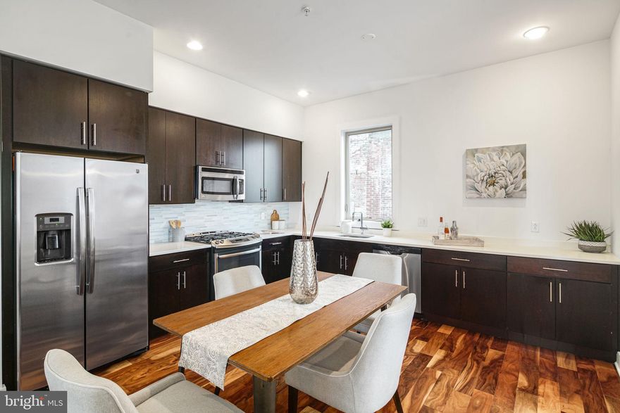 Gorgeous townhome in Northern Liberties with attached garage parking and roof deck! Through the front door you'll be greeted by the extremely spacious living area that flows to the gorgeous eat-in kitchen with ample countertop and cabinet space. Upstairs boasts three graciously sized bedrooms fitted with massive closets with custom floor to ceiling shelving. The master suite has a spacious layout with ample sunlight, a huge walk in closet, and spa style bathroom. There is a full size wet bar and wine fridge next to a doorway leading to the giant roof deck with outstanding views waiting for you to entertain and/or relax. You also have your own attached 1 car parking garage. Taxes and square footage are to be verified by the buyer independently. * Photos are of another home in the development and may not depict actual finishes.