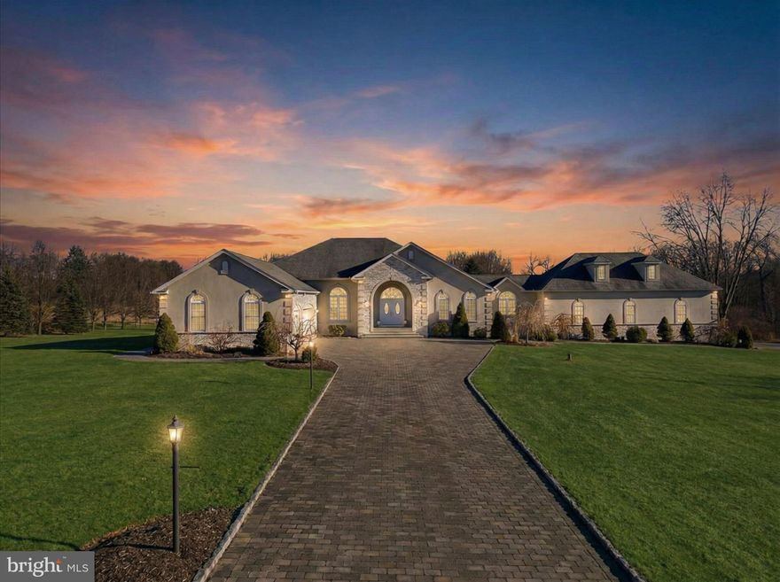 There is a difference between owning a home and owning control.

Set across 12.75 private acres in Bushkill Township within the Nazareth Area School District, 901 Meyer Road is a fully modernized single-level estate designed for those who value privacy, infrastructure, and permanence. Portions of the acreage are enrolled in Act 319 and protected under Wildlands Conservancy guidelines, reinforcing long-term preservation of the surrounding landscape.

Approached by a long private drive, the residence is positioned with meaningful setback from the road and buffered by mature tree lines that limit sightlines and create true separation. This is not acreage for speculation. It is acreage for privacy.

Since acquisition, current ownership completed approximately $550,000 in documented improvements, transforming the home from original-condition finishes into a refined, turnkey estate.

The interior was comprehensively reimagined with new oak hardwood flooring throughout, full Sherwin-Williams repainting of walls and ceilings, expanded recessed lighting, upgraded electrical finishes, and enhanced security systems. Every space now reflects continuity in tone, finish, and scale.

The kitchen was fully reconstructed with new white and black cabinetry, Carrara marble and granite countertops, oversized island with integrated power, stainless steel appliance package including double oven with convection, under-cabinet lighting, updated backsplash, and Italian porcelain flooring. It functions as both workspace and gathering point.

All bathrooms were renovated. The primary suite features dual-head oversized shower with stone flooring, custom glass enclosure, Carrara marble double-sink configuration, soaking tub, Toto bidet, and high-end hardware. Secondary baths were rebuilt with new tile, vanities, fixtures, and Toto toilets.

The dining room was elevated with a propane in-wall fireplace finished in stone and supported by dedicated propane infrastructure. Custom built-ins and lighting enhance scale without overwhelming the room.

The finished lower level provides additional flexible living space with updated ceiling systems, carpeting, and lighting.

Outdoor living was redesigned with two paver patios, stone steps, landscaping enhancements, fire pit, concrete walkways, and pool improvements. Infrastructure updates include a new underground 500-gallon propane tank supporting radiant and basement heating. Seven CCTV cameras and upgraded alarm systems reinforce security and oversight.

Outbuildings and garage structures provide flexibility for vehicles, storage, equipment, or hobby use. The layout supports functionality without disrupting residential privacy.

What distinguishes this offering is not simply acreage or square footage. It is the combination of preserved land, documented modernization, established infrastructure, and immediate livability. Recreating this setting today would require land acquisition, extended timelines, rising construction costs, and regulatory navigation. Here, it is complete.

901 Meyer Road represents an opportunity to acquire a fully updated private estate with long-term preservation, modern finishes, and estate-scale positioning within reach of Philadelphia, New York and New Jersey markets.