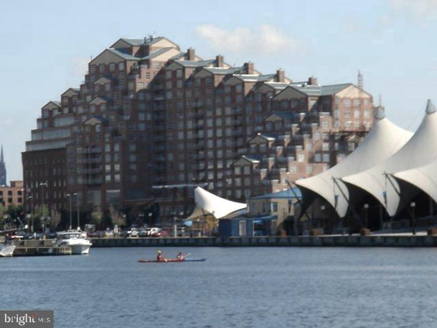 Terrific waterfront 2 bedroom, 2 bath condo in desirable Scarlett Place Condominium! This light filled residence boasts walls of windows and a desirable floor plan.  The condominium has been renovated and features:  a lovely gourmet kitchen with wood cabinetry, granite countertops, stainless steel appliances, a spacious living room with built-in cabinetry , separate dining area with balcony access to enjoy sweeping views of the water and cityscape, en-suite Primary Bedroom and Bath,  a second bedroom and full bath and wood flooring throughout.  One assigned garage parking space and in-unit washer and dryer are provided.  Amenities include an indoor pool,  fitness center, recreation room, 24 hour front desk attendant and security.  The building is ideally located at the vertex of Little Italy, the Inner Harbor, and Harbor East.  It is an easy walk to restaurants, bars, shopping, public transportation, cultural events, and various other neighborhoods, and has easy access to Johns Hopkins, U of M Medical Centers, major roads and highways, the stadiums, MARC train and Penn Station. No Pets.